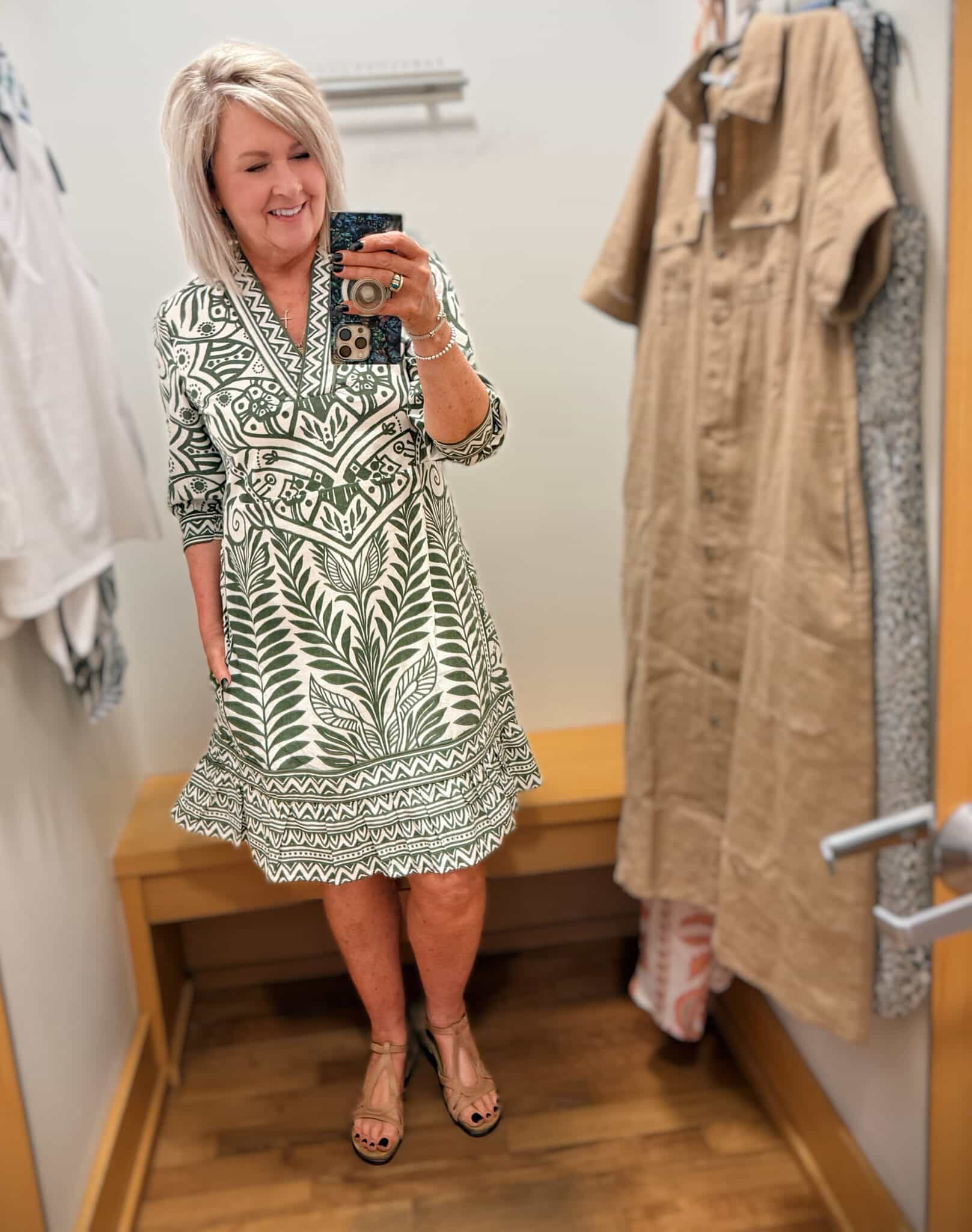 Tania wearing a green and white printed V-neck dress from Chico's