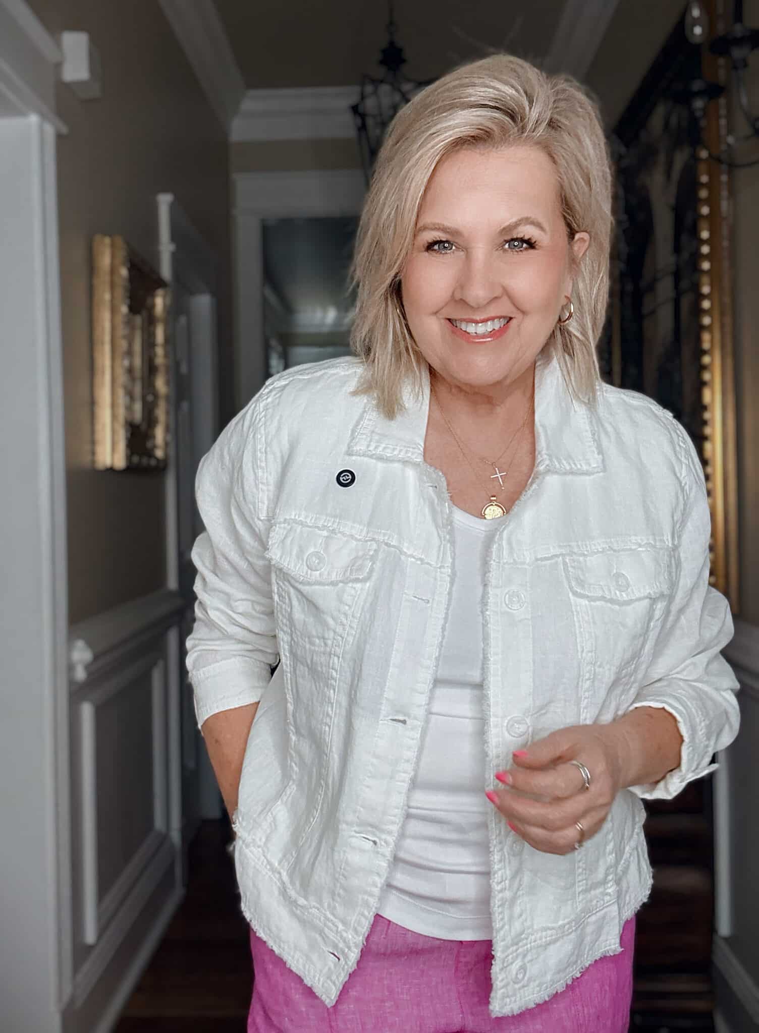 Tania wearing a white tank with a white linen jacket