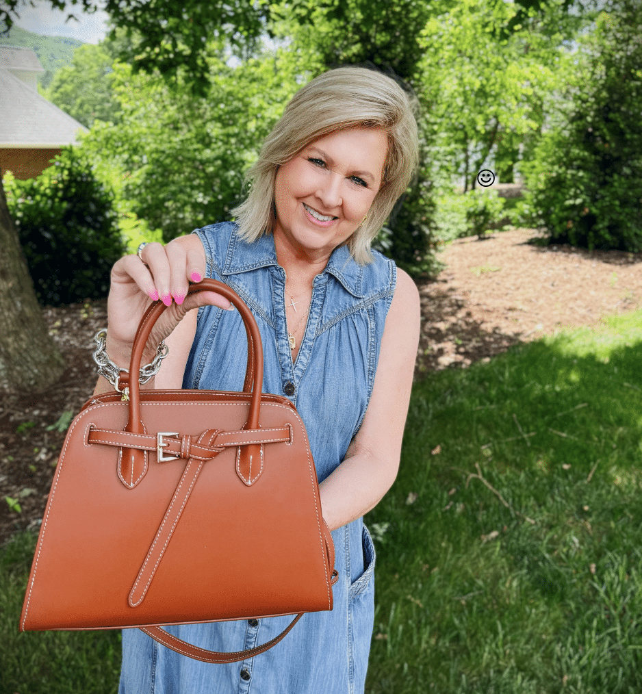 Brown bowler bag with tie detail and contrast stitching styled with chambray dress