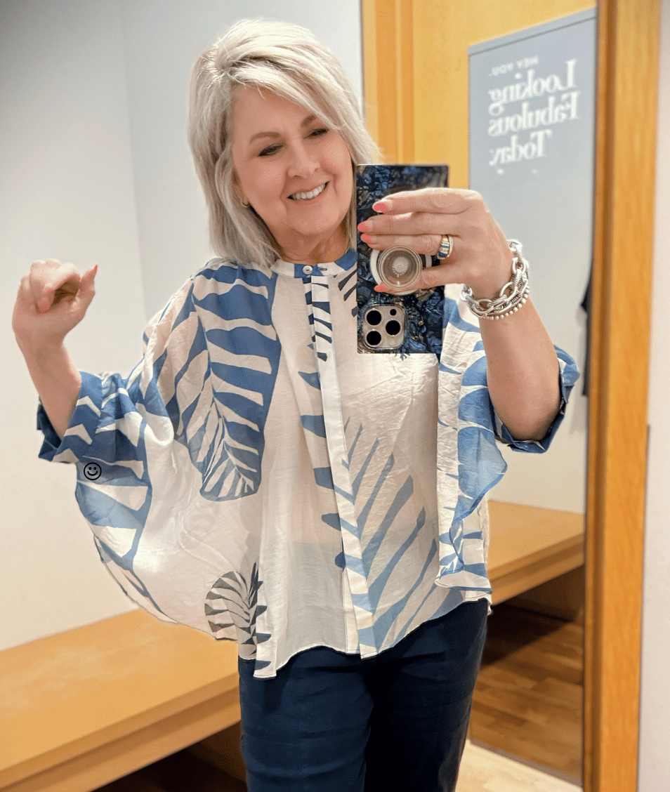 Tania wearing a sheer blue button poncho top from Chicos