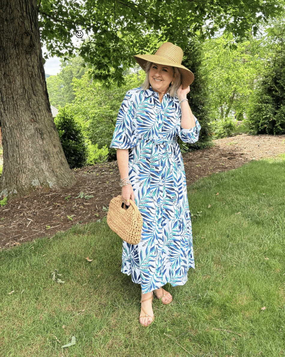 Tania wearing a straw sunhat with a palm print dress from Chico's