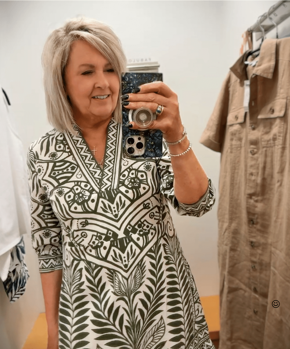 Tania wearing a green and white printed V-neck short dress from Chico's