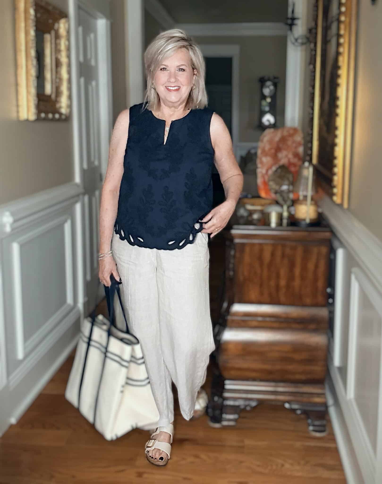 Tania wearing a navy eyelet top with wide leg linen pants from J.Jill