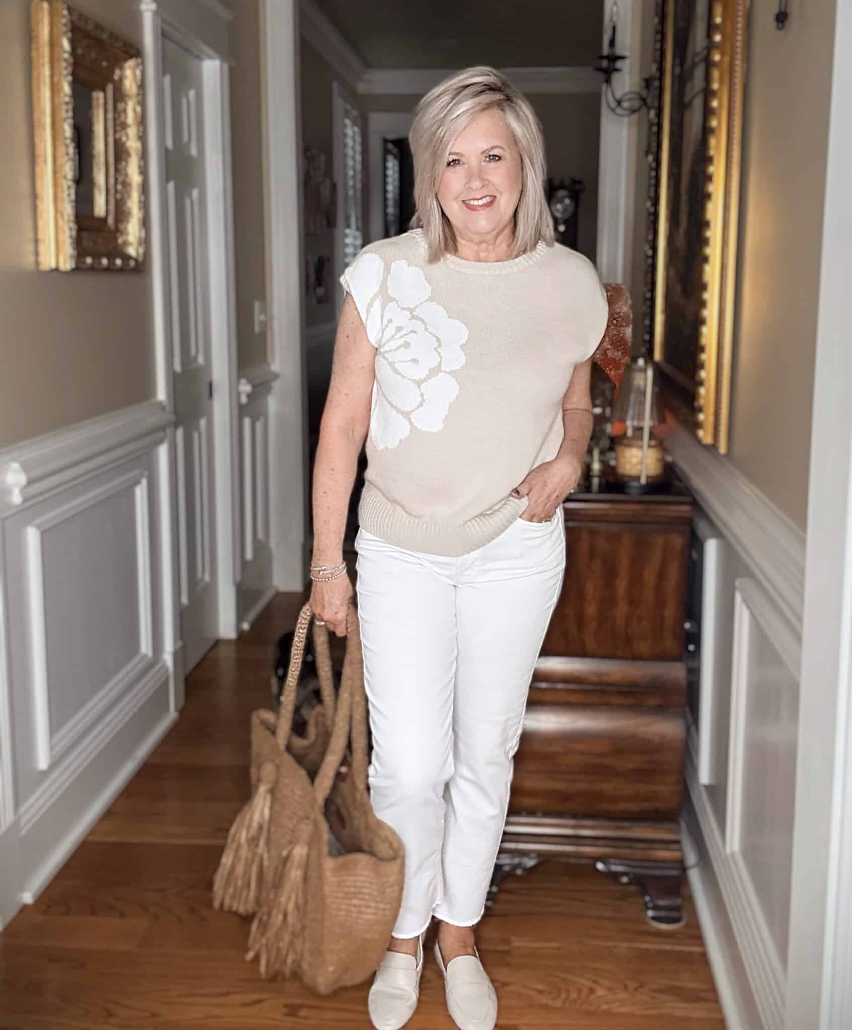 Tania wearing a neutral floral sweater with white jeans from J.Jill