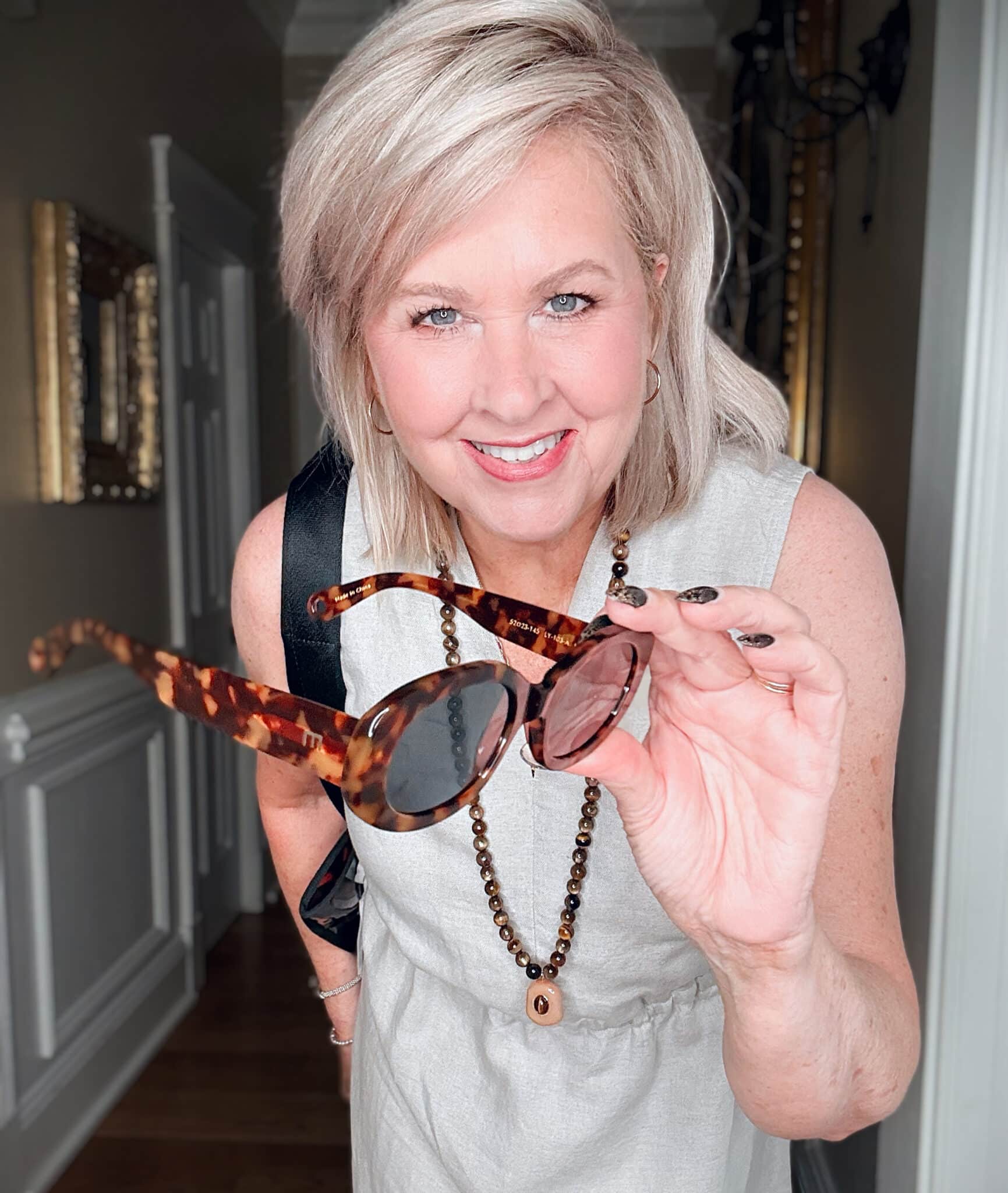 Tania wearing a neutral maxi dress from J.Jill with tortoise print sunglasses