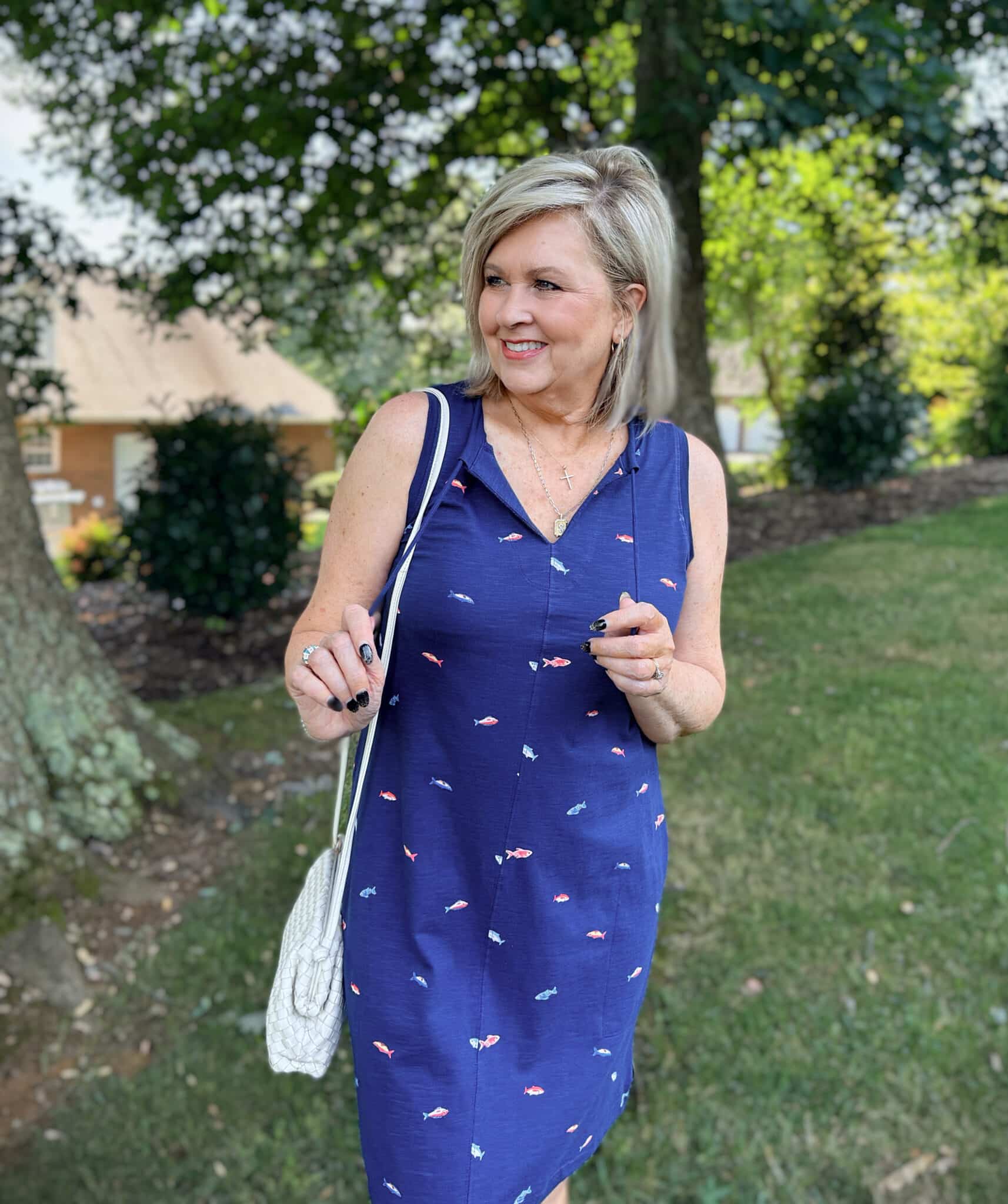 Tania wearing a navy fish printed dress from Kohl's