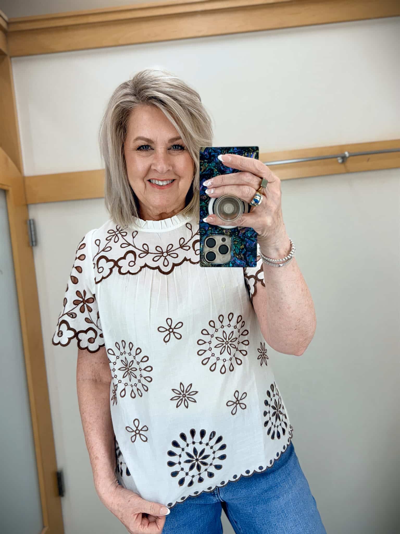 Tania wearing a white top with brown accents from Talbots