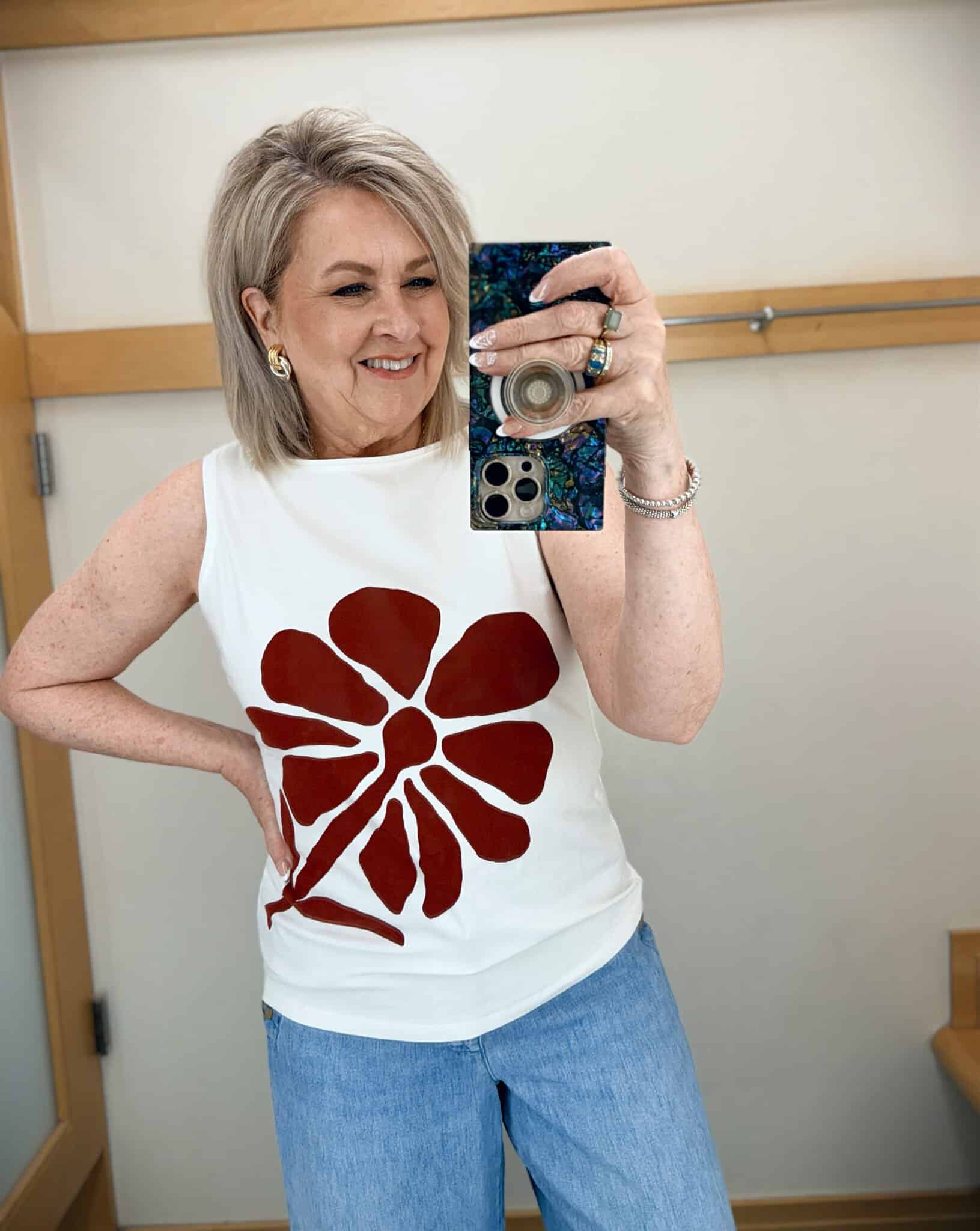 Tania wearing a white boatneck top with a floral design from Talbots