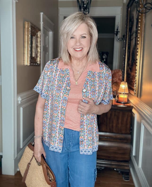 Tania wearing a mosaic camp shirt over a peach tank from Tommy Bahama