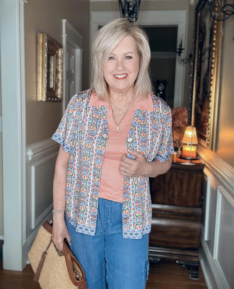 Tania wearing a mosaic camp shirt over a peach tank from Tommy Bahama