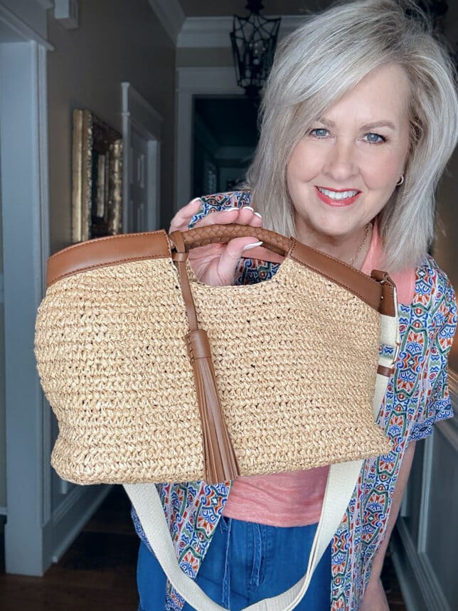 Tania holding a raffia, leather trimmed bag from Apatchy in London
