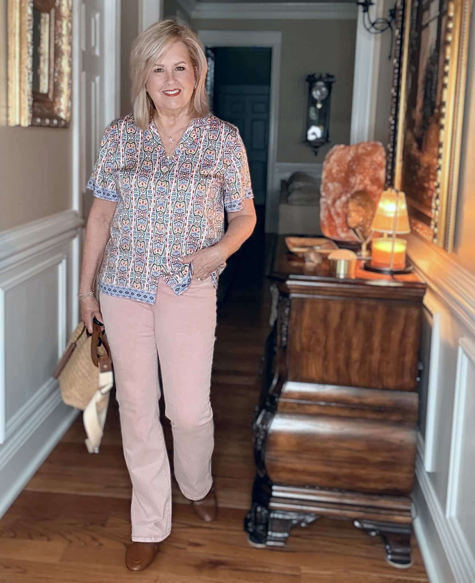 Tania wearing a mosaic camp shirt with peach colored jeans from Noli