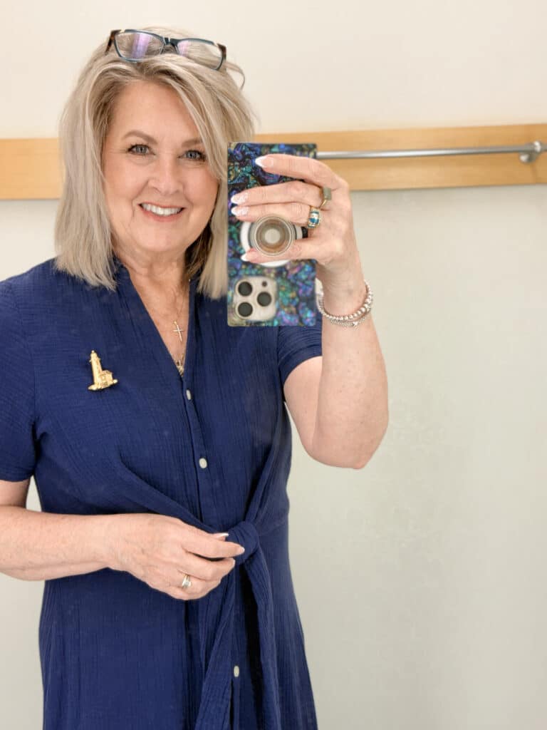 Tania wearing a lighthouse brooch on a navy gauze dress