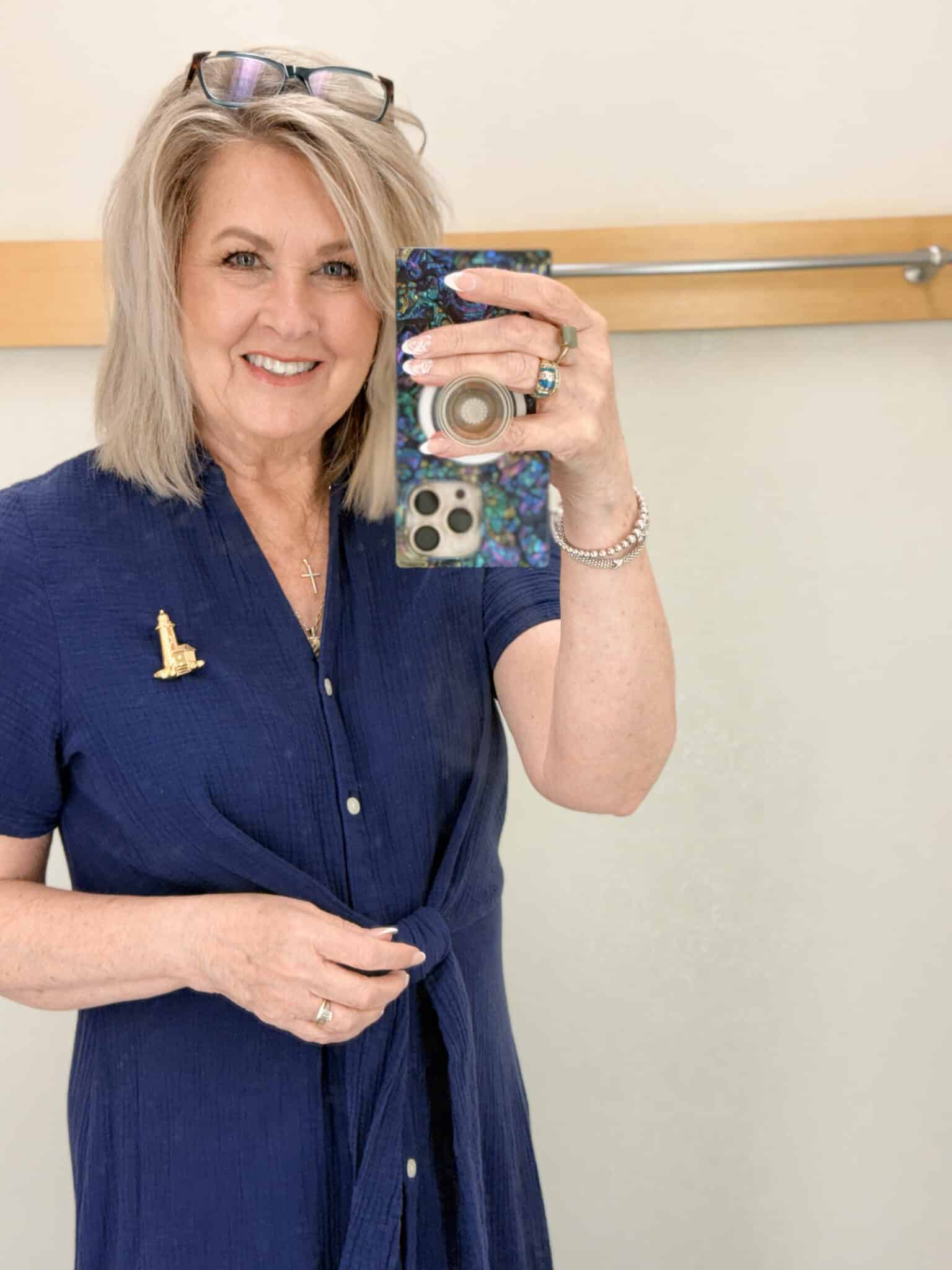 Tania wearing a lighthouse brooch on a navy gauze dress