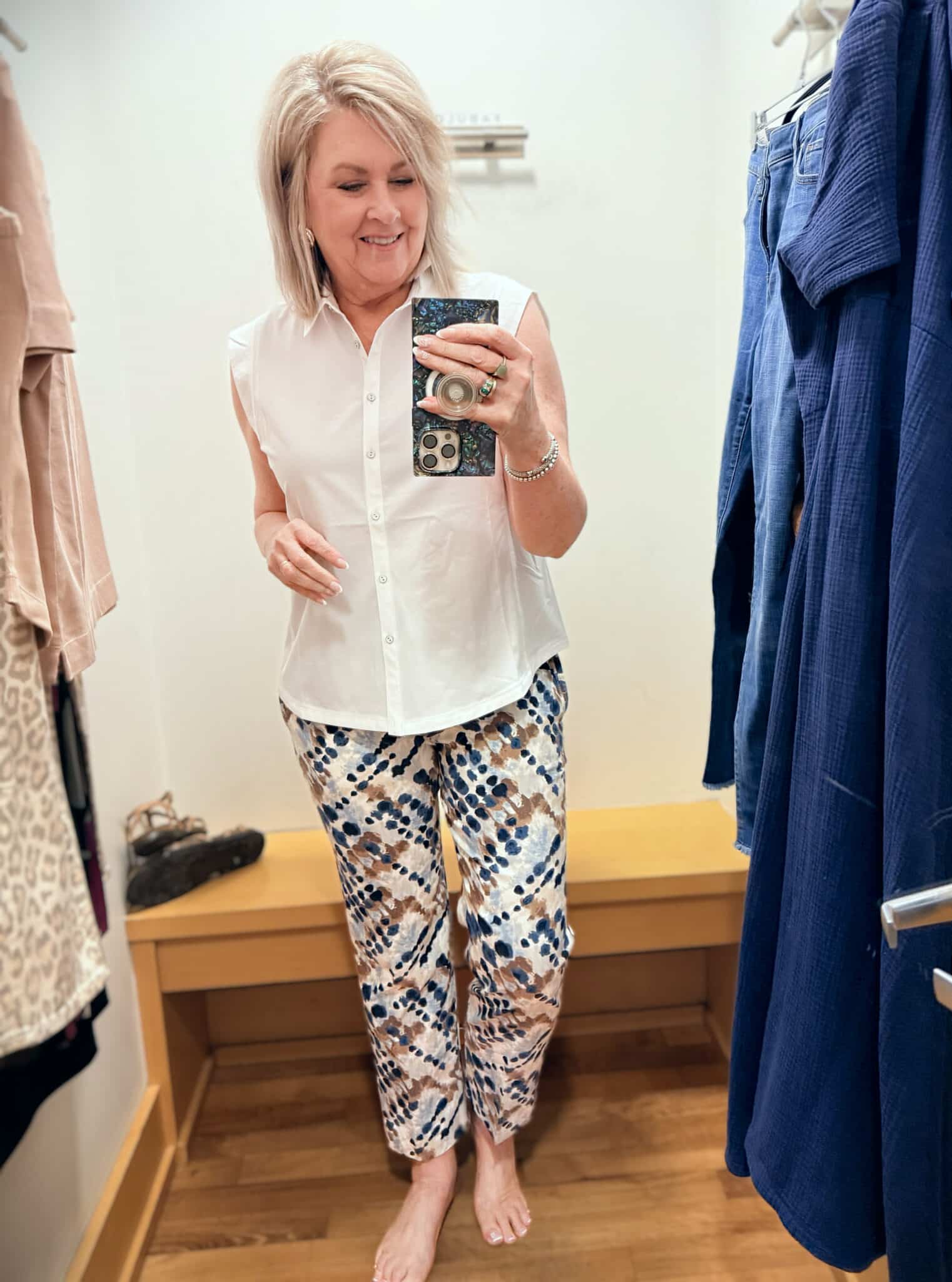 Tania wearing a white sleeveless shirt with printed pants from Chico's