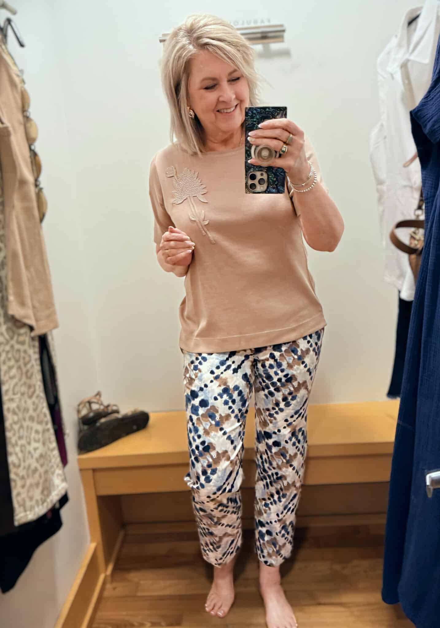Tania wearing a light brown embroidered tee with printed pants from Chico's
