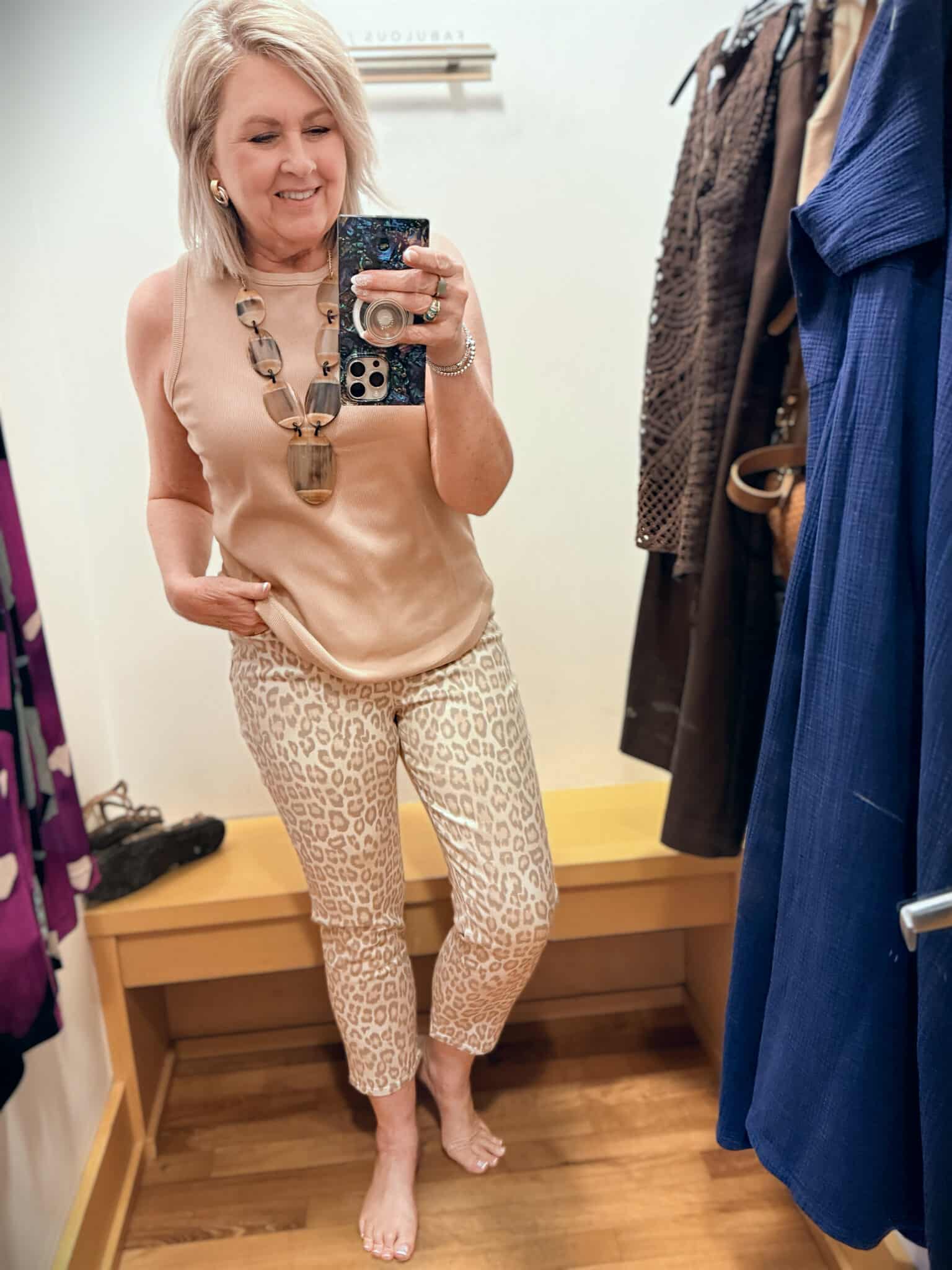 Tania wearing a tan ribbed tank with animal print pants from Chico's