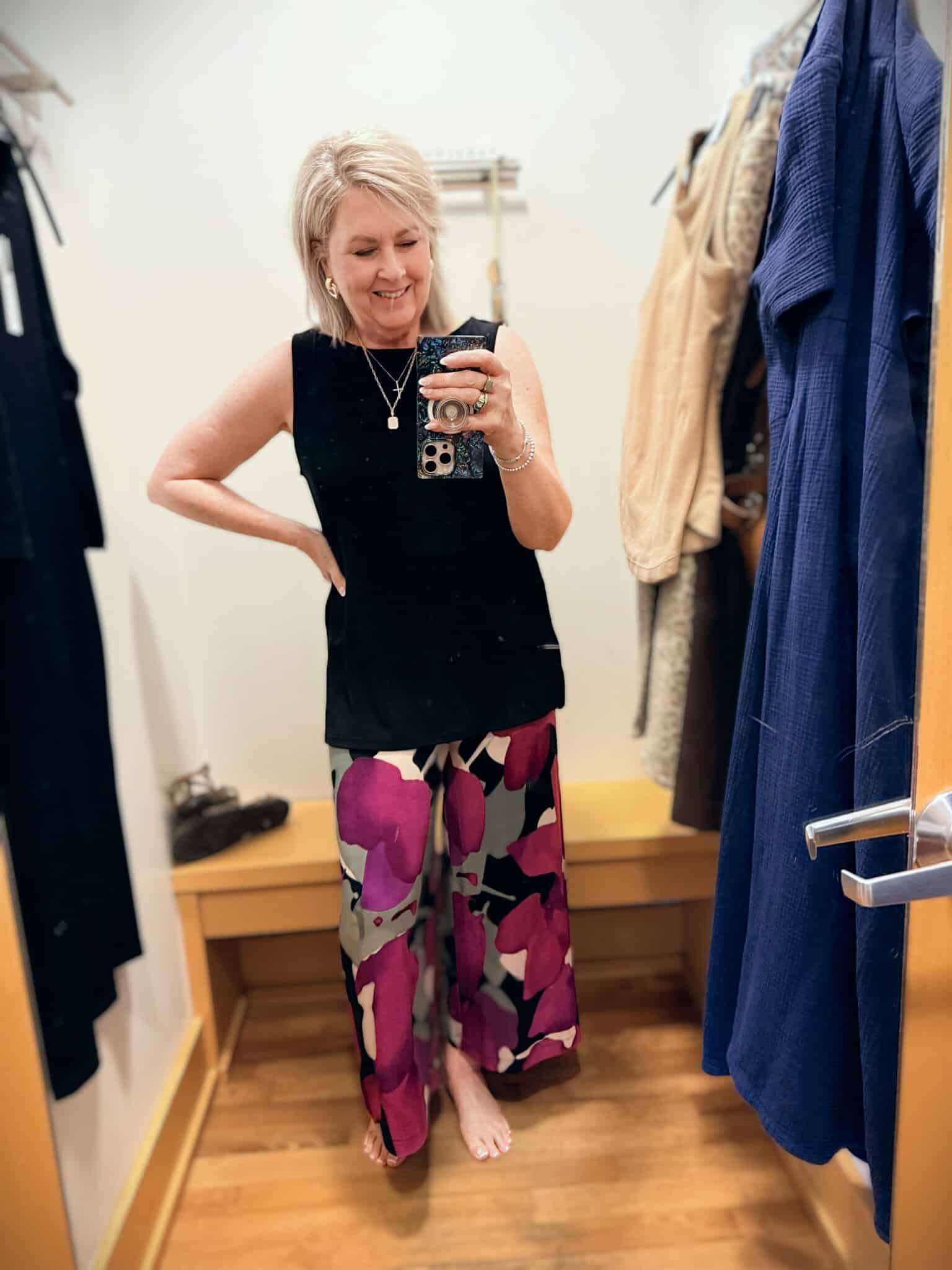 Tania wearing a black tunic tank and brightly colored wide leg pants from the Zenergy line at Chico's