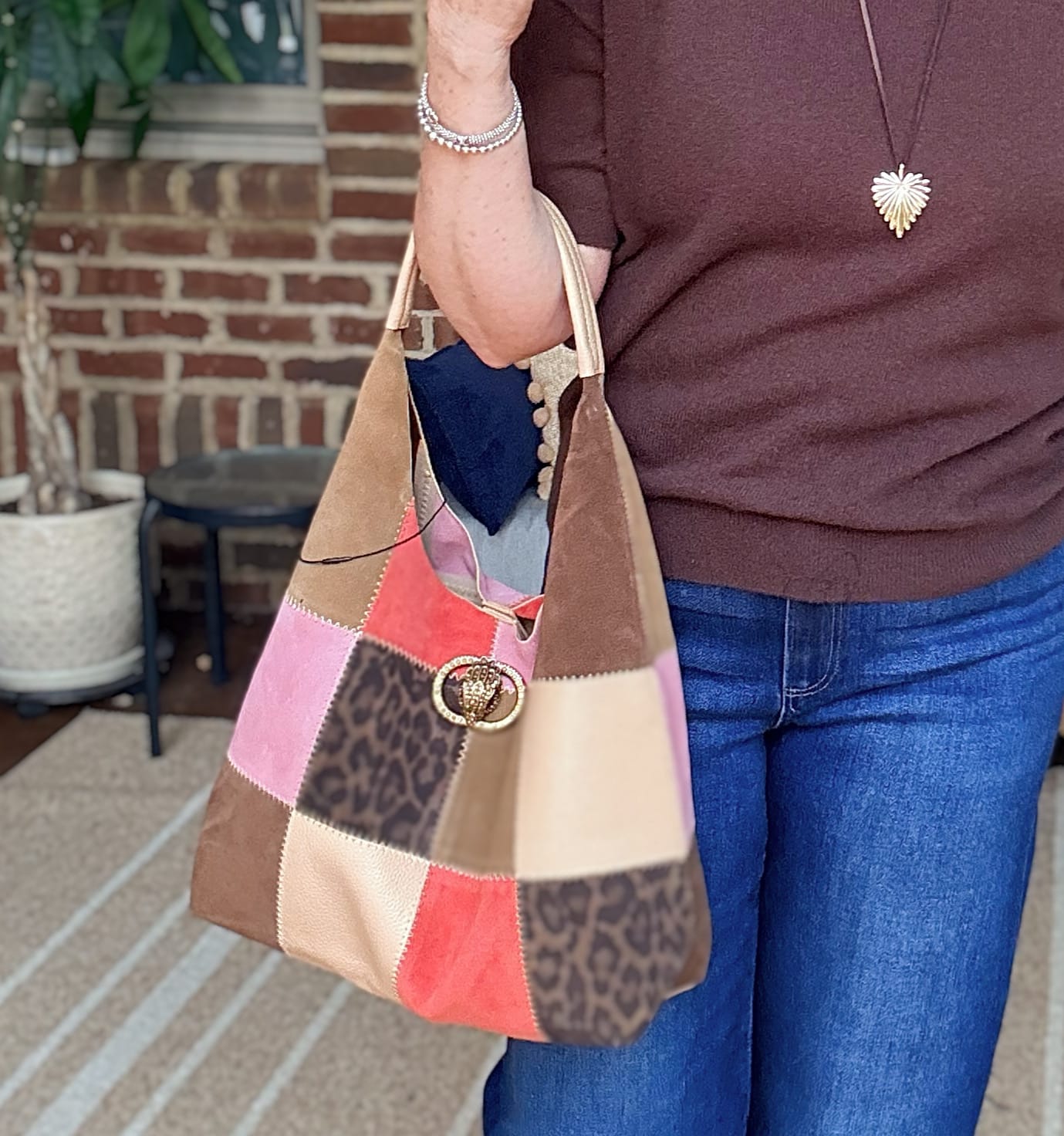 Tania carrying a patchwork handbag by Kurt Geiger from Nordstrom