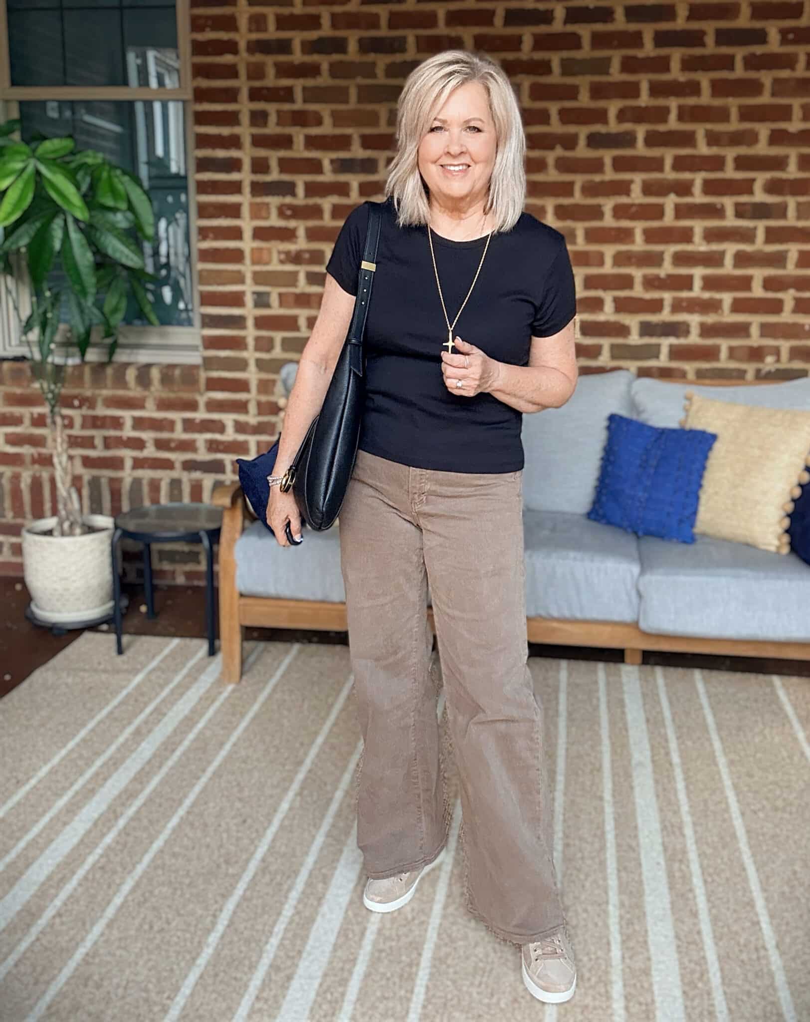 Tania wearing a black tee with Paige brown wide-leg jeans from Nordstrom