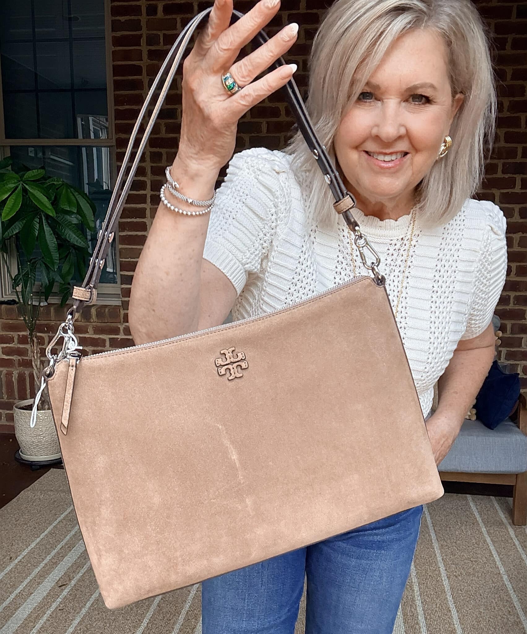 Tania carrying a neutral Tory Burch handbag  from Nordstrom