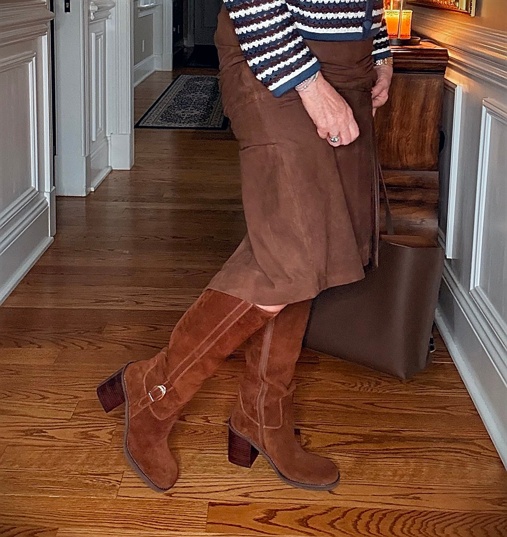 Tania wearing a brown suede midi skirt with Blondo knee boots