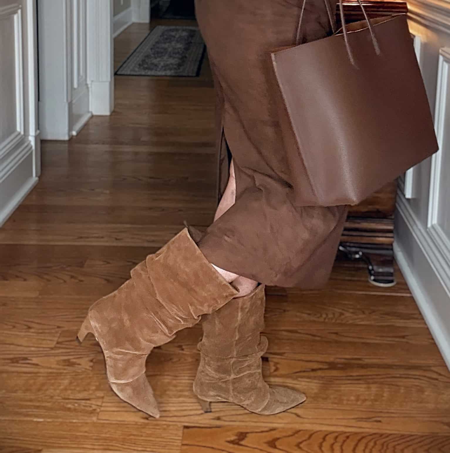 Tania wearing a brown suede midi skirt with Ash scrunch boots
