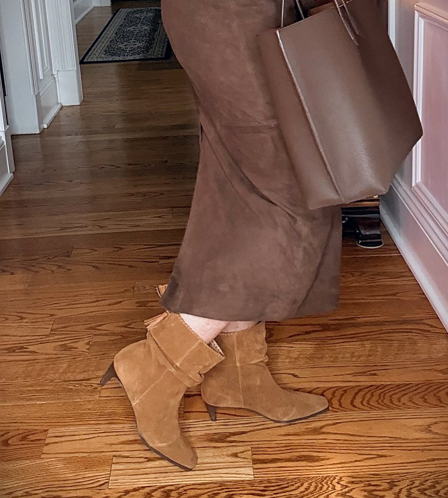 Tania wearing a brown suede midi skirt with Splendid scrunch boots