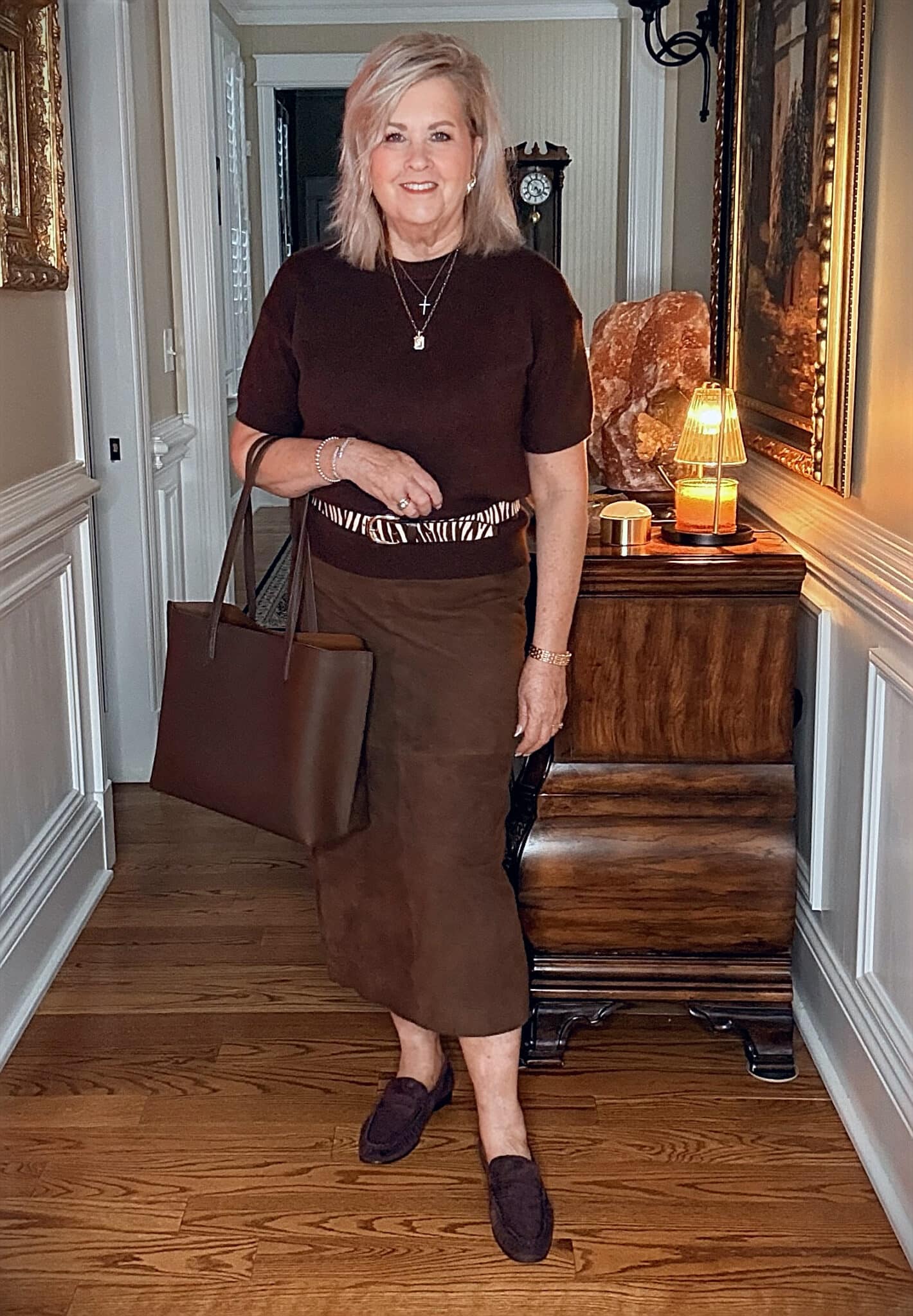 Tania wearing a brown cashmere sweater with a suede midi skirt with chocolate brown loafers from Nordstrom