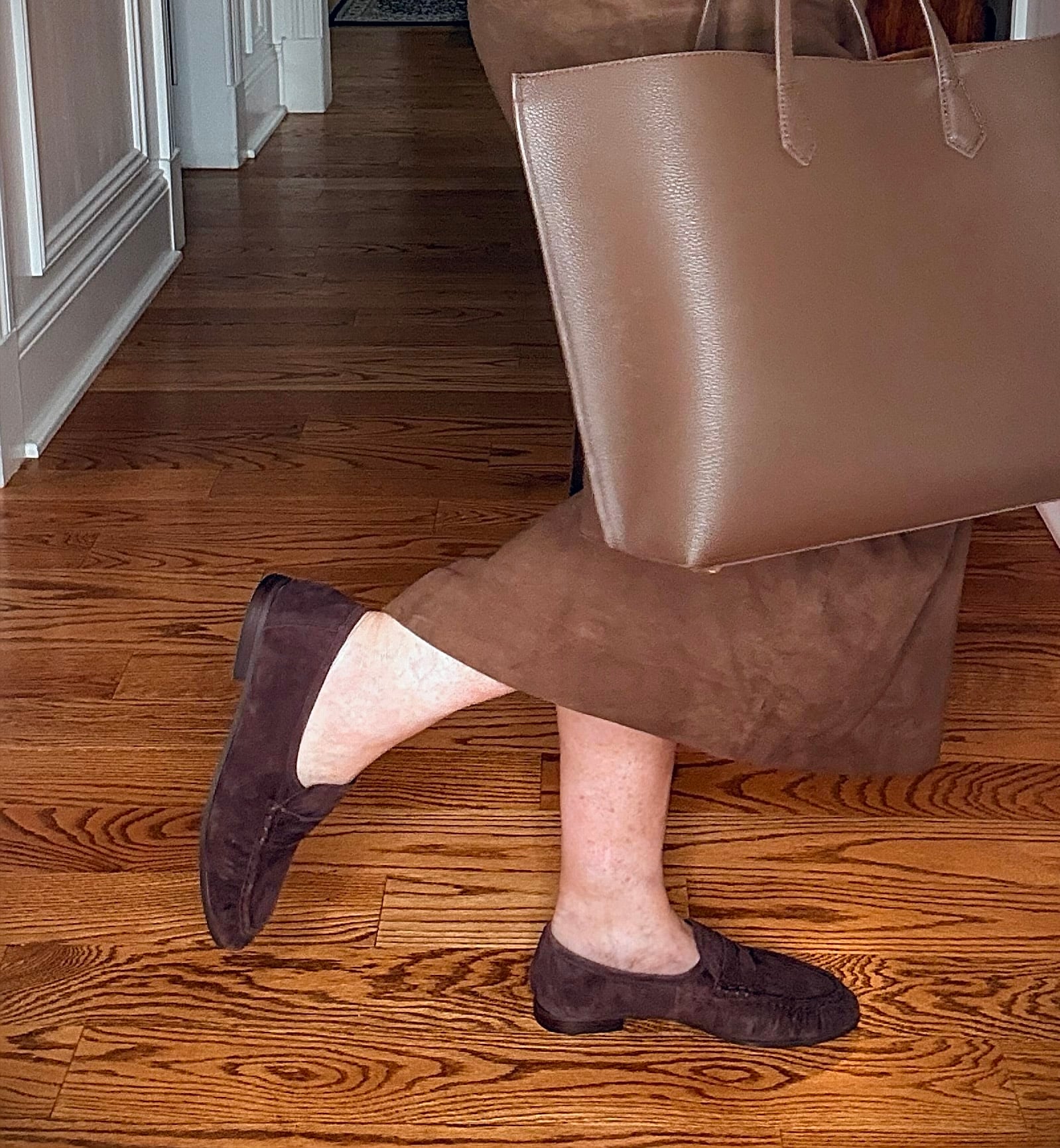 Tania wearing a brown cashmere sweater with a suede midi skirt with chocolate brown loafers