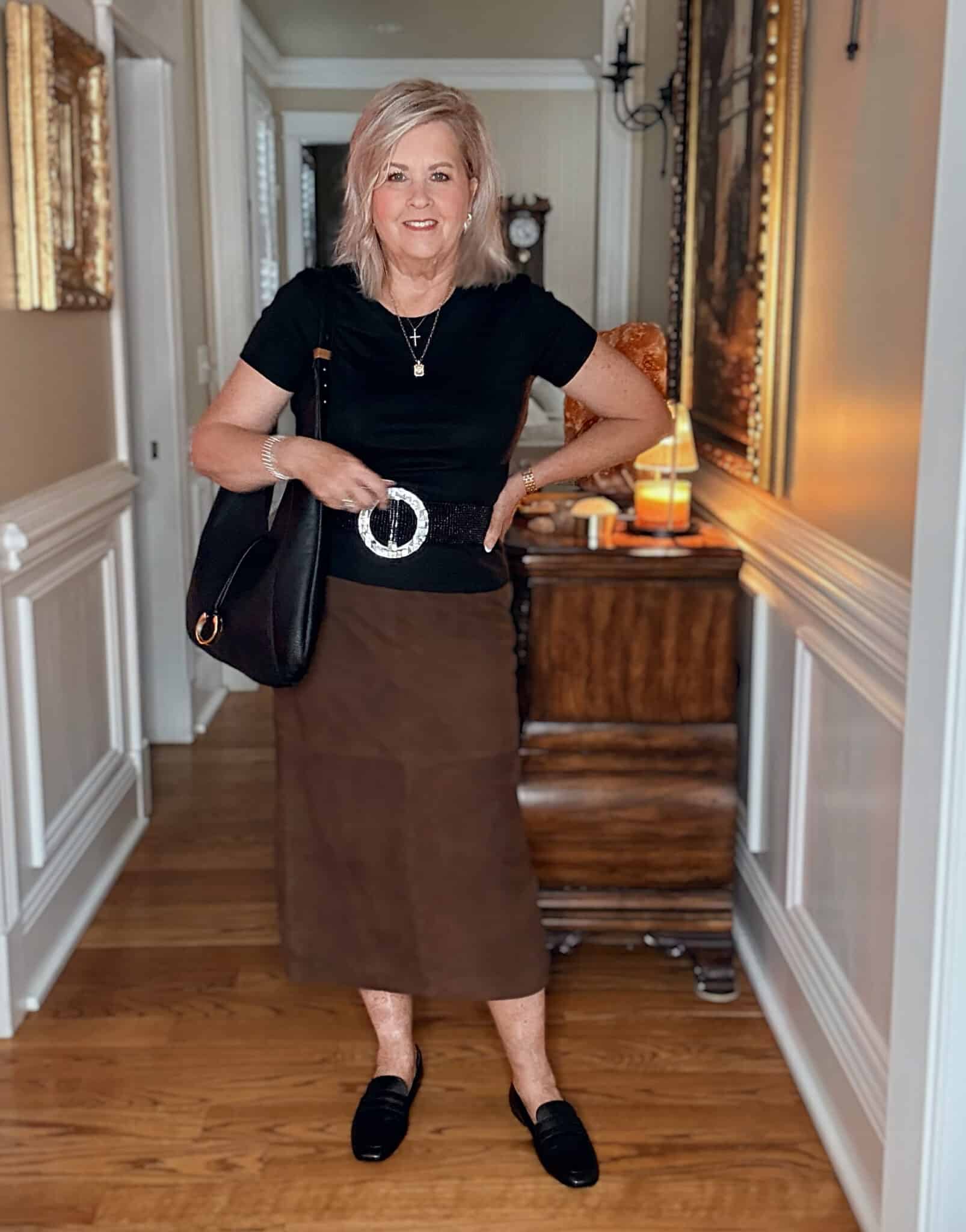 Tania wearing a black t-shirt with a suede midi skirt with Vionic black loafers from Nordstrom