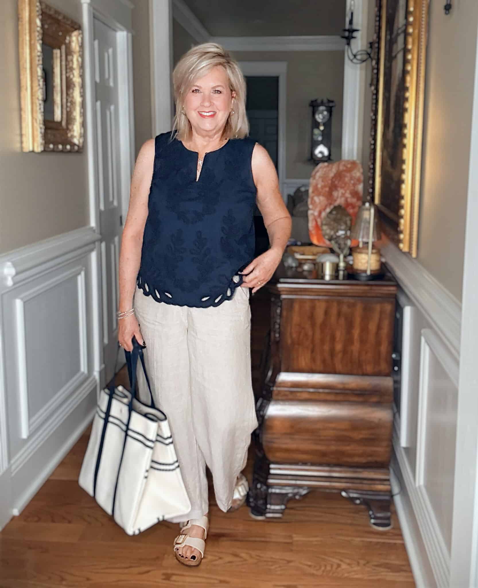 Tania wearing a navy embroidered tank with linen pants