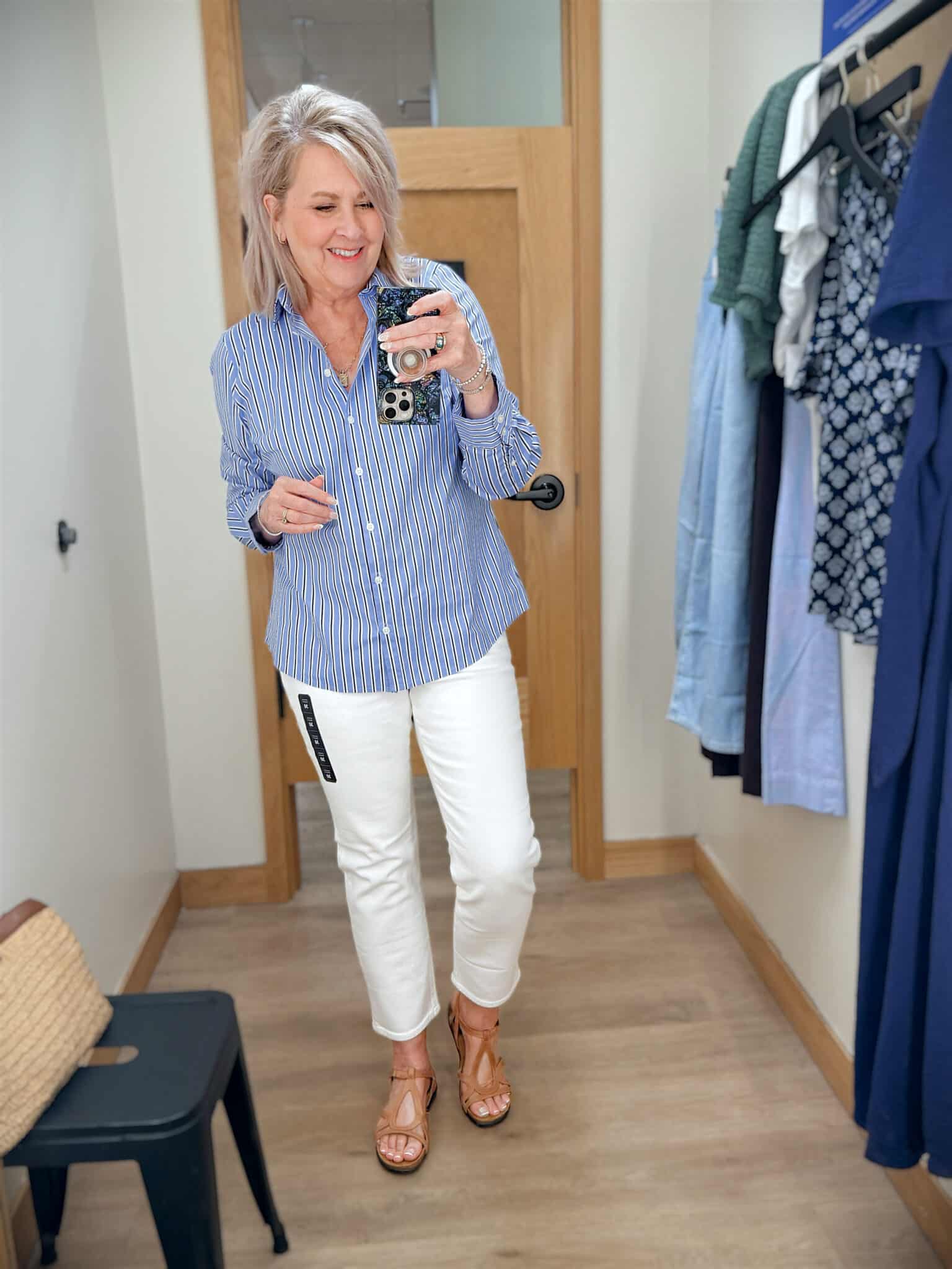 Tania wearing white jeans with a blue stripe button shirt from JCrew Factory