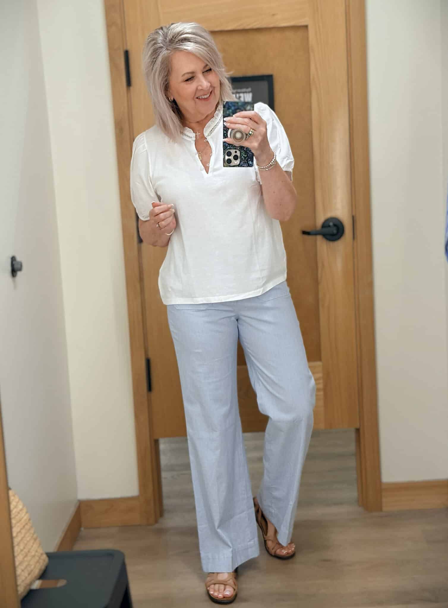 Tania wearing a white puff sleeve top with pinstripe crops from J.Crew Factory