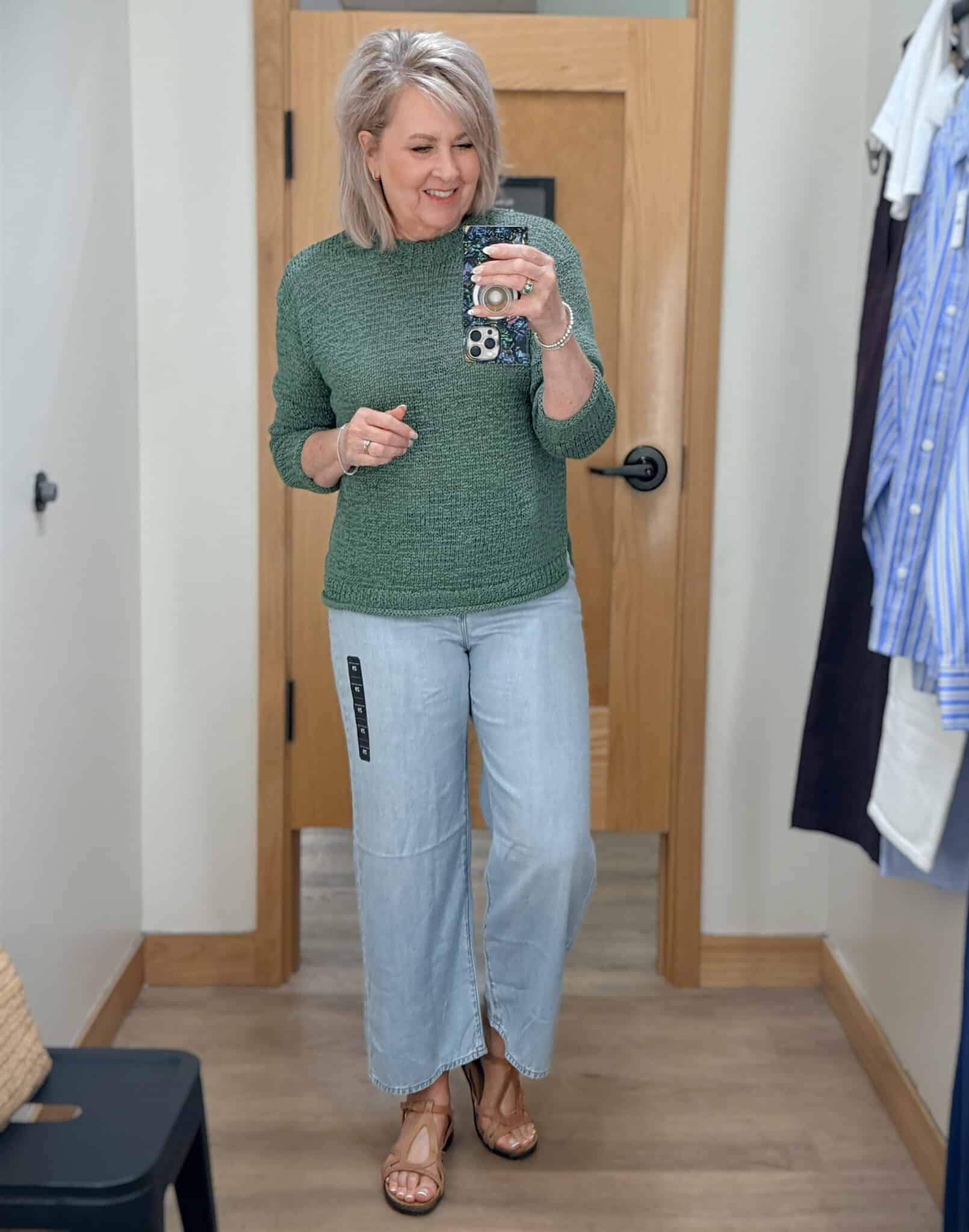 Tania wearing a green lightweight sweater with lightwash jeans from J.Crew Factory