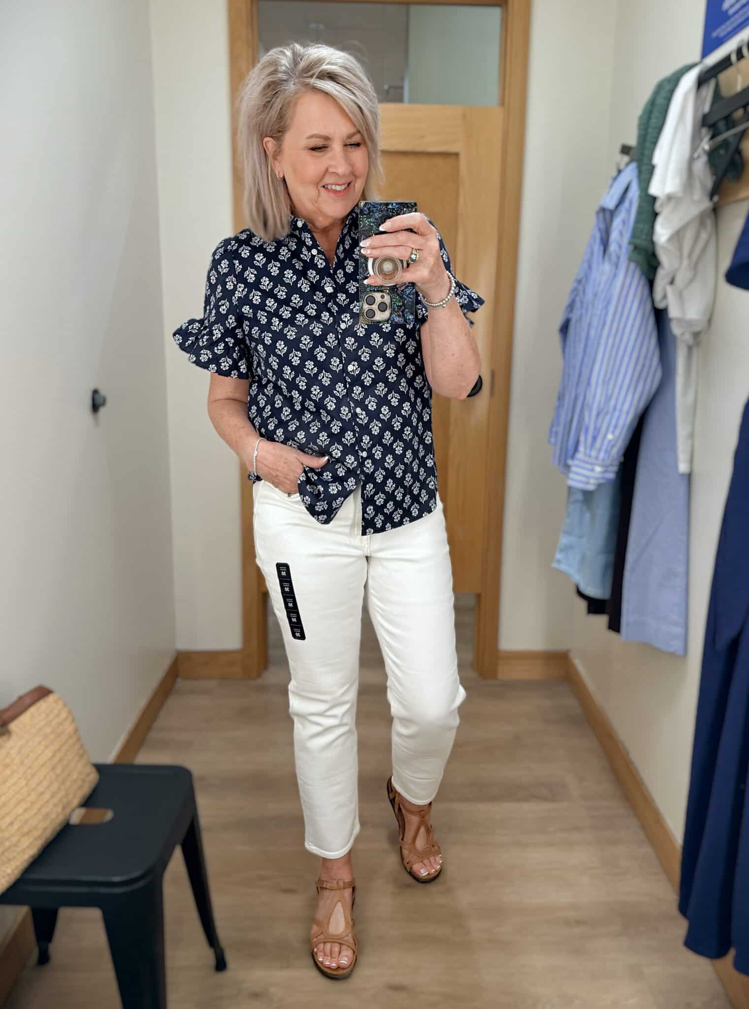 Tania wearing a navy & white button shirt with white straight leg jeans from J.Crew Factory