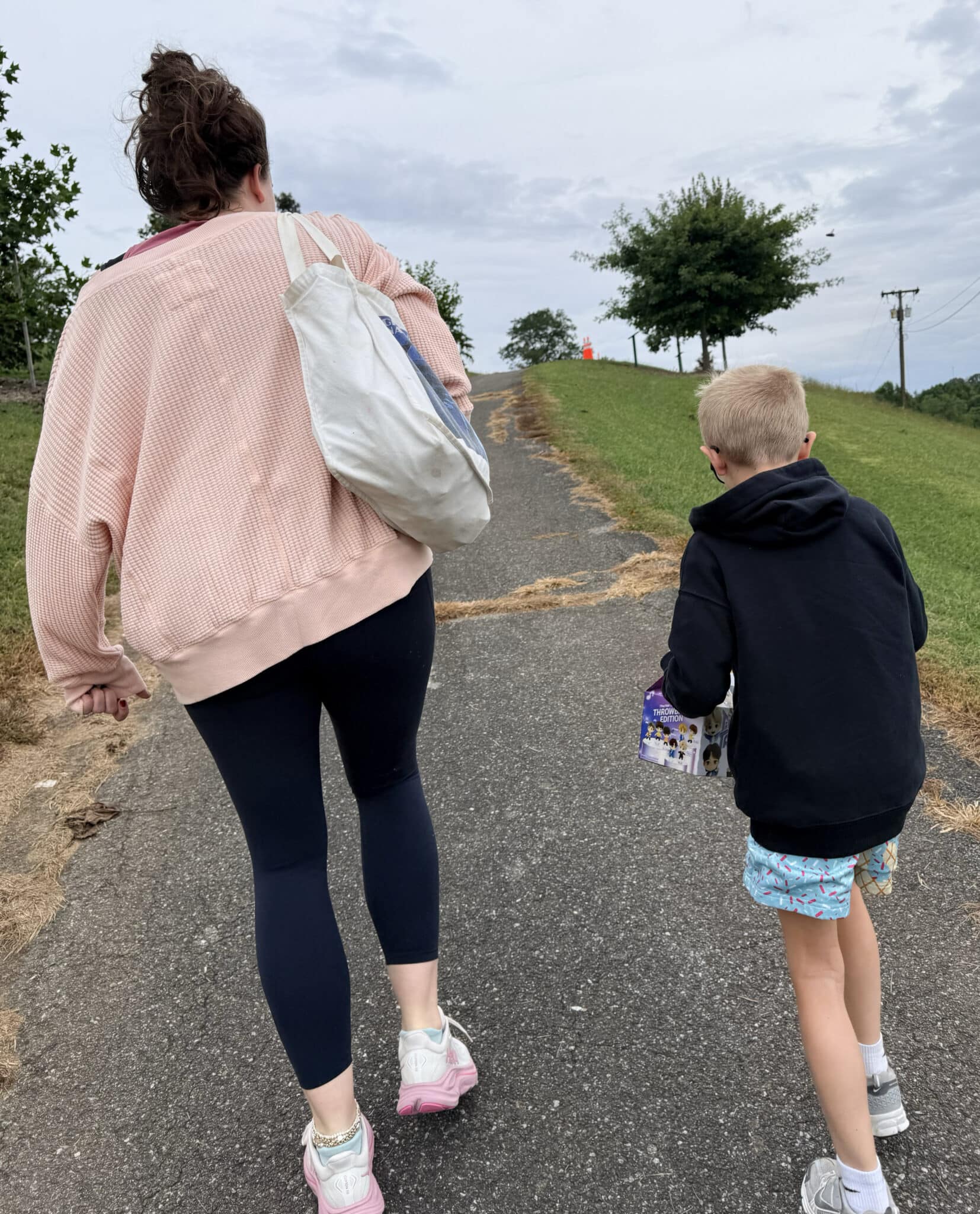 Ashleigh and Beckham walking up a hill to a park