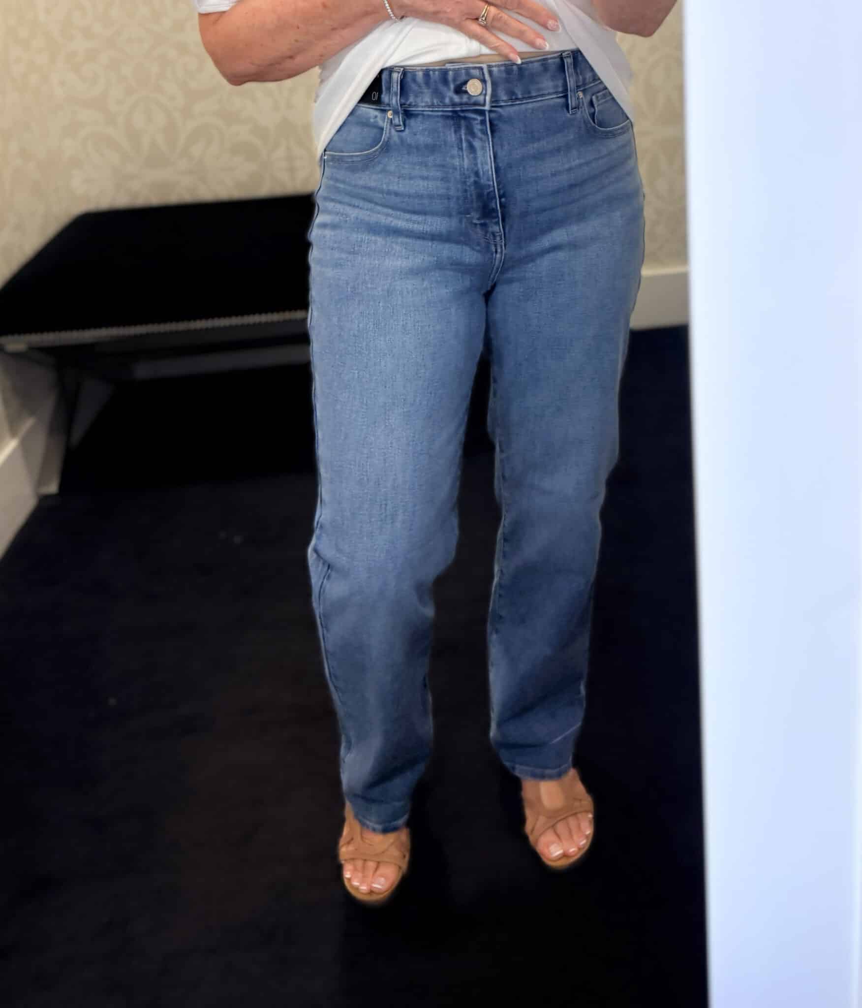Tania wearing medium wash jeans from White House Black Market
