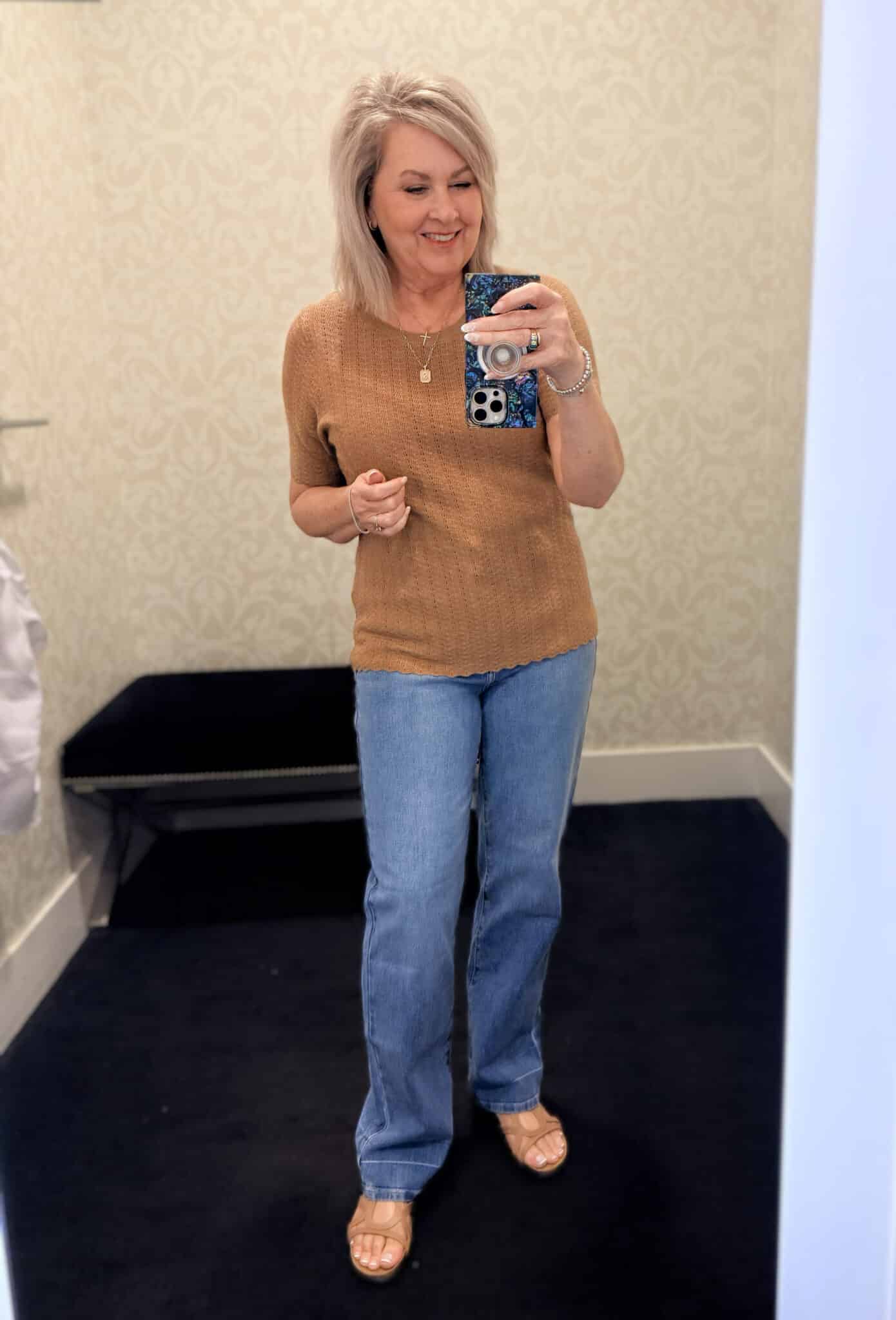 Tania wearing a camel ribbed top with medium wash jeans from White House Black Market