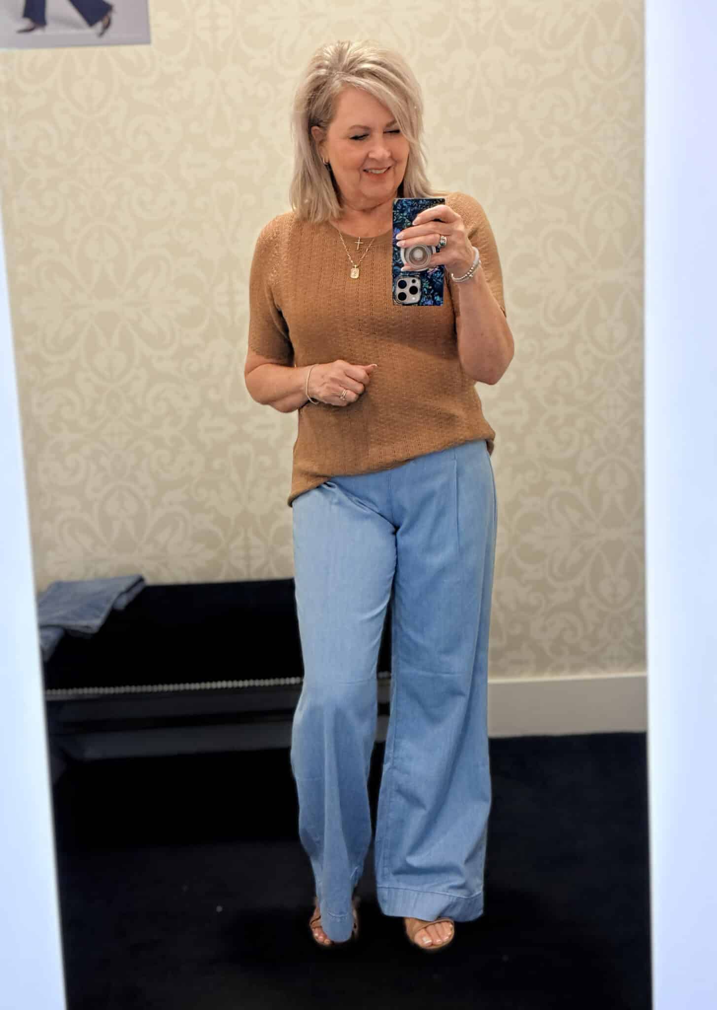 Tania wearing a camel ribbed top with light wash sailor style jeans from White House Black Market