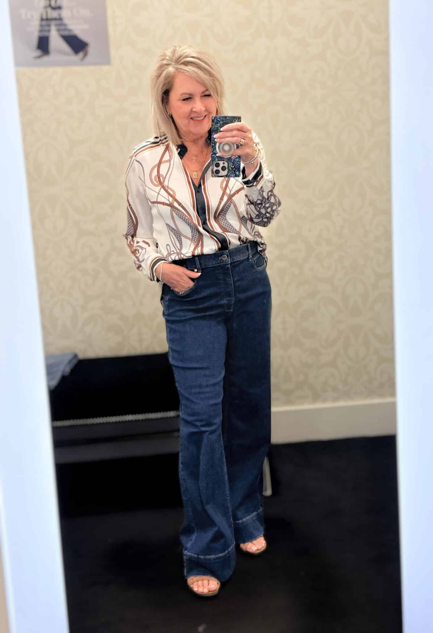 Tania wearing a satin printed blouse with dark wash jeans from White House Black Market