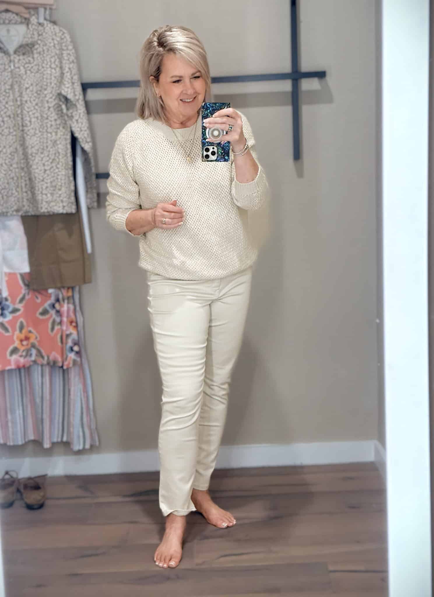 Tania wearing a beige beach sweater with slim ankle jeans from Tommy Bahama for fall transition