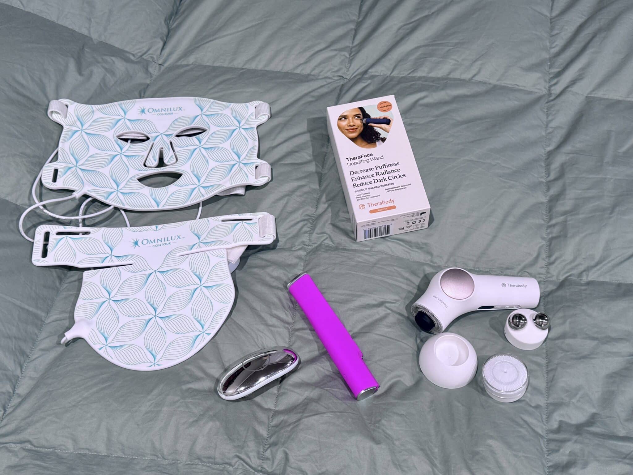 Skincare tools on a bed