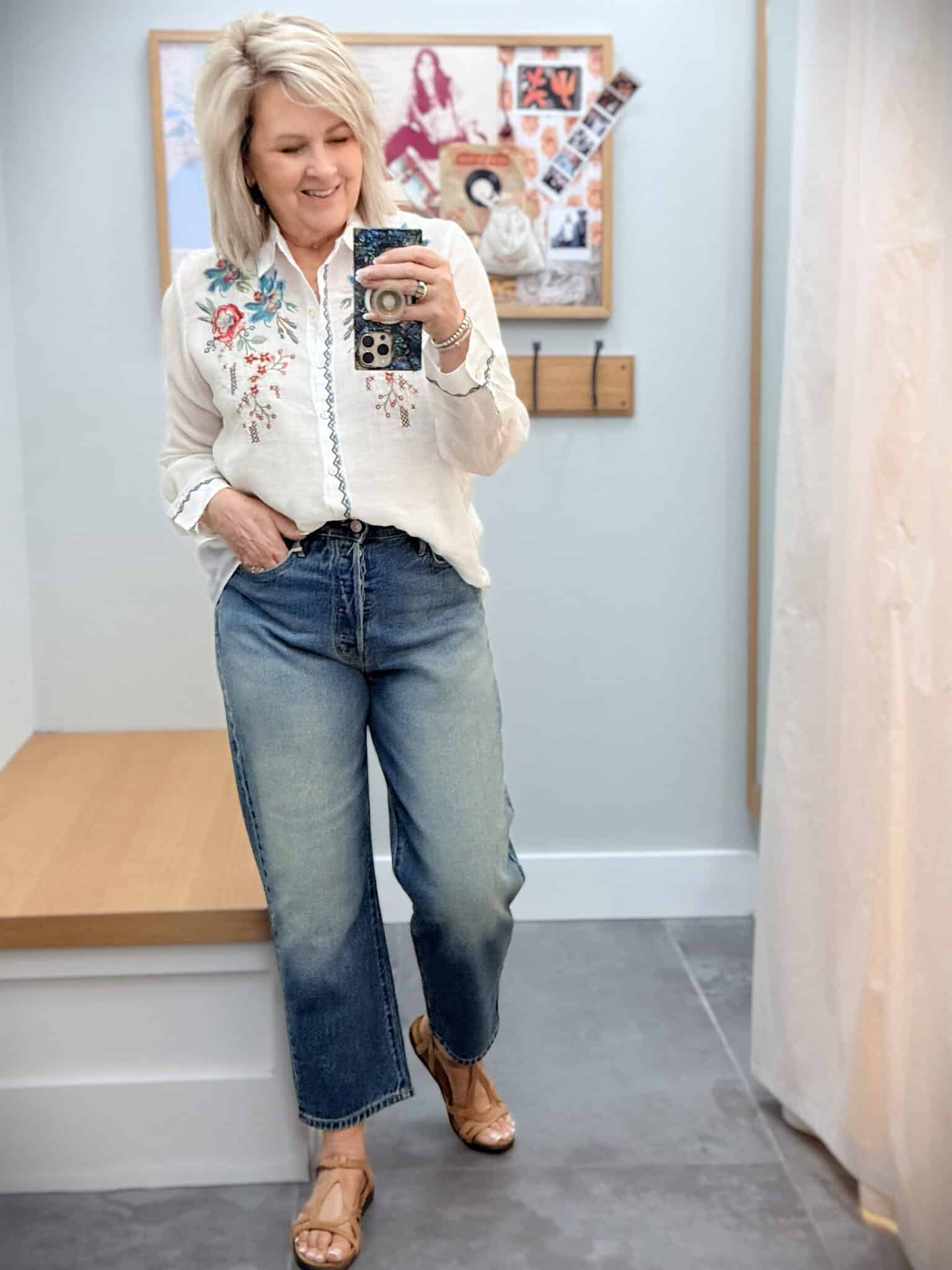 Tania wearing a Johnny Was button up embroidered top with barrel leg jeans