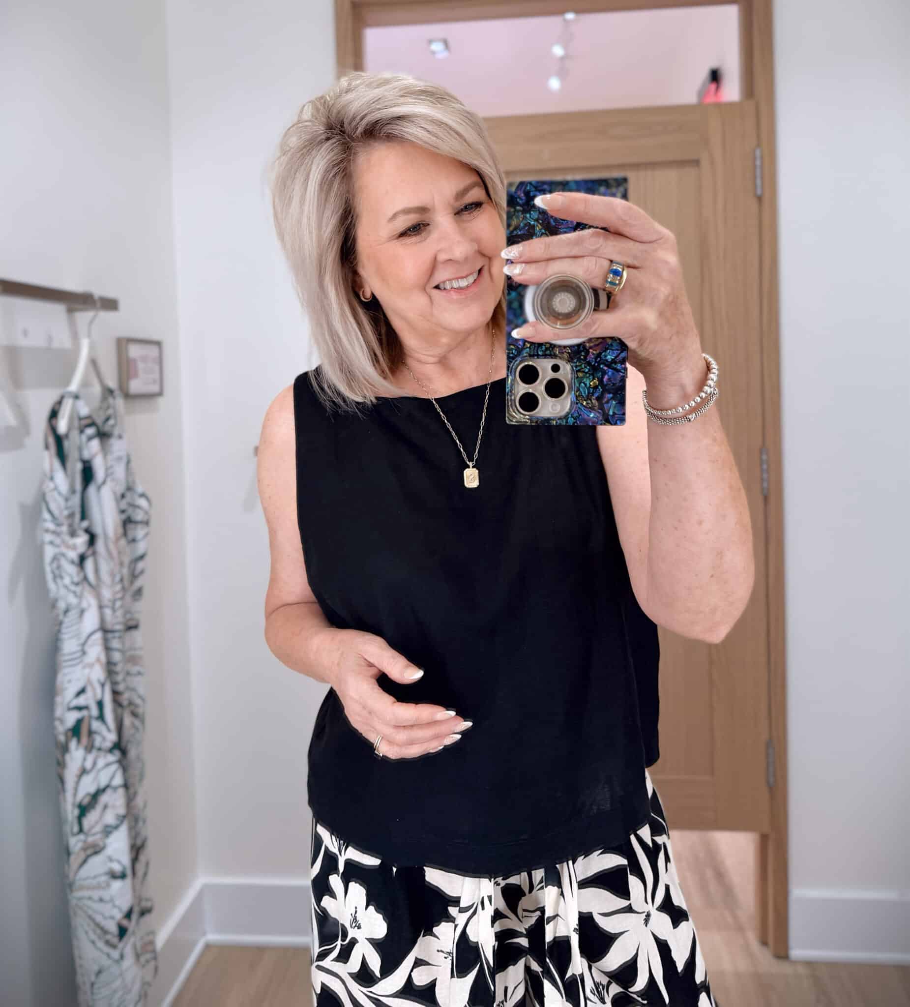 Tania wearing a black sleeveless shirt from Ann Taylor