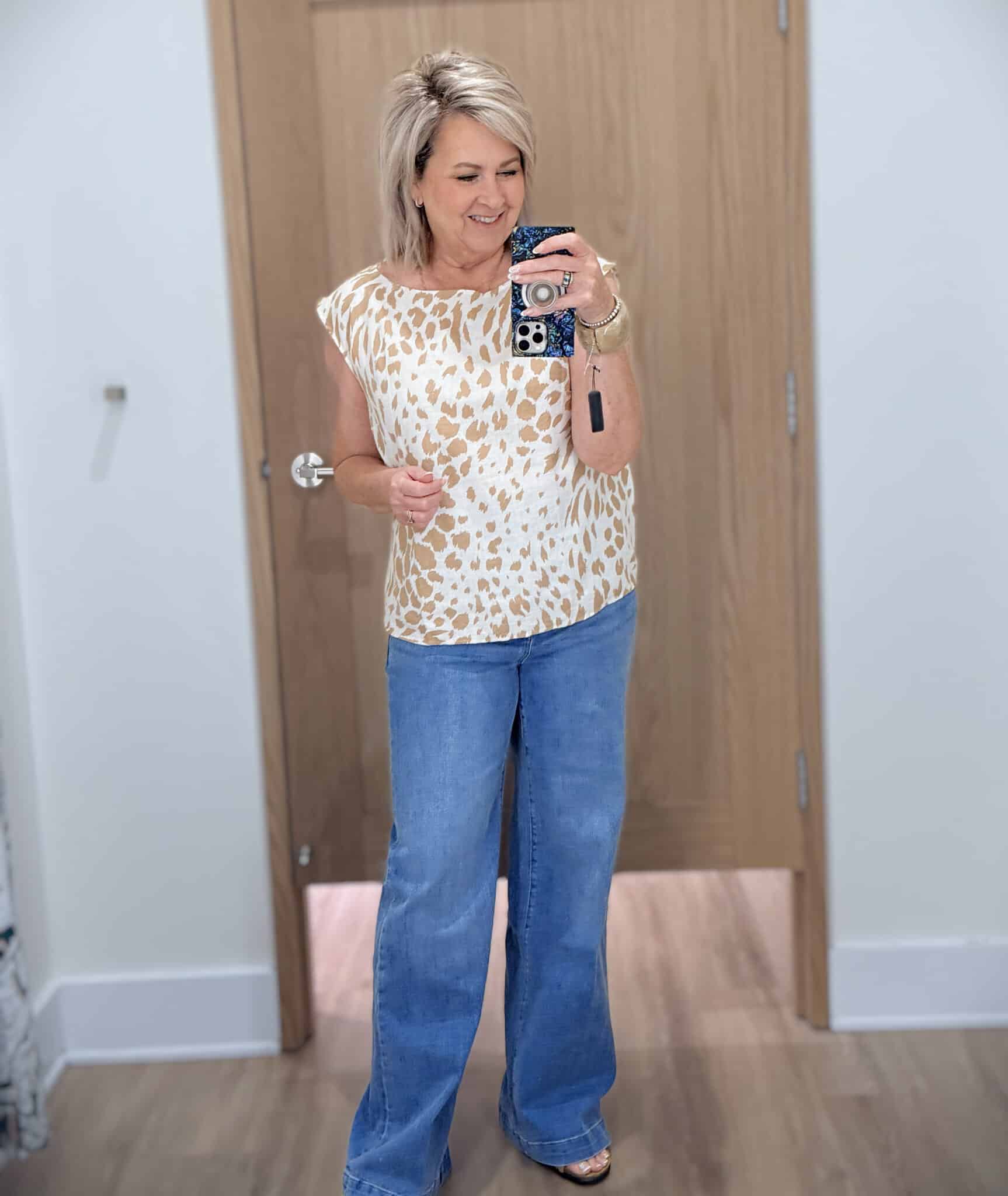 Tania wearing a animal print shirt with wide leg trouser jeans from Ann Taylor