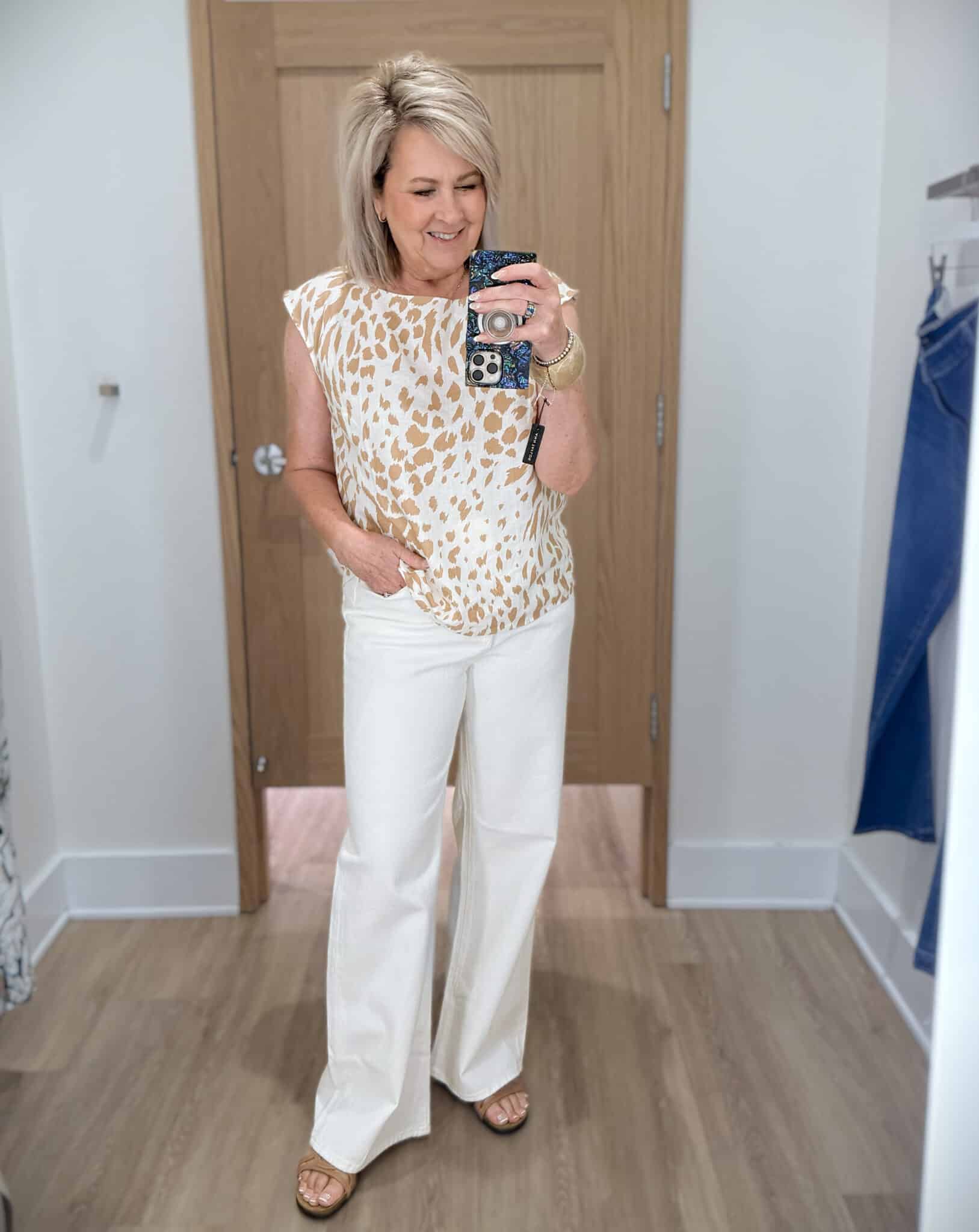Tania wearing a animal print shirt with white wide leg trouser jeans from Ann Taylor