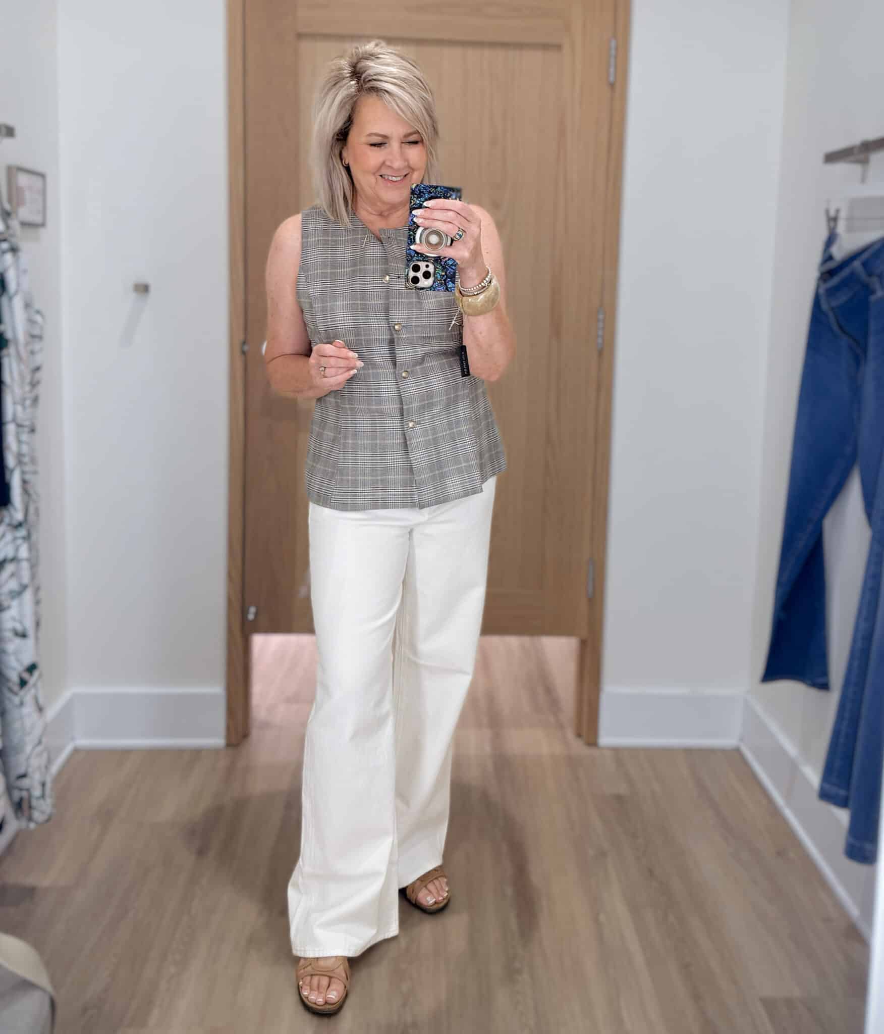 Tania wearing a plaid vest with white wide leg trouser jeans from Ann Taylor