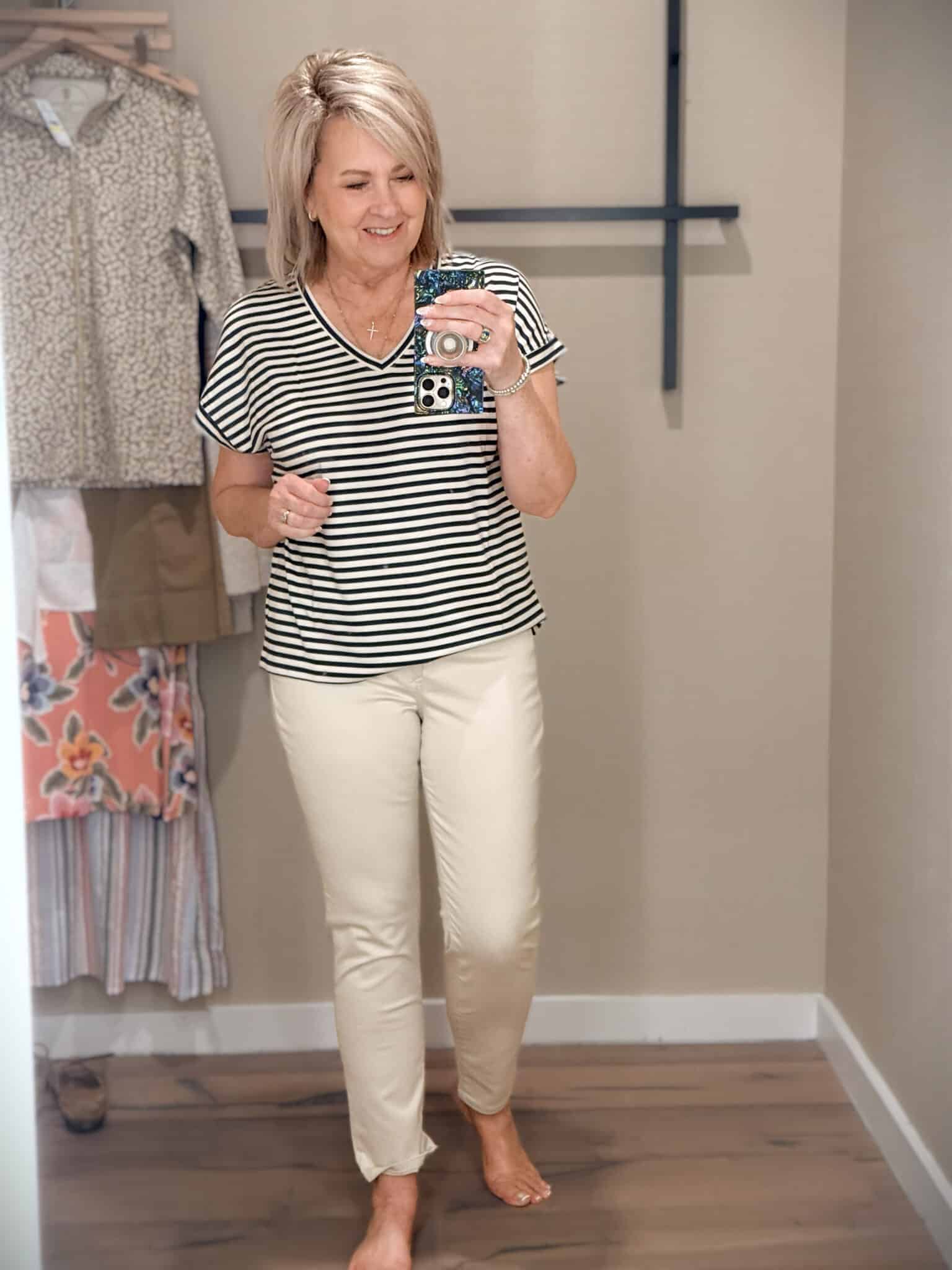 Tania wearing a striped v-neck shirt and ivory jeans from Tommy Bahama