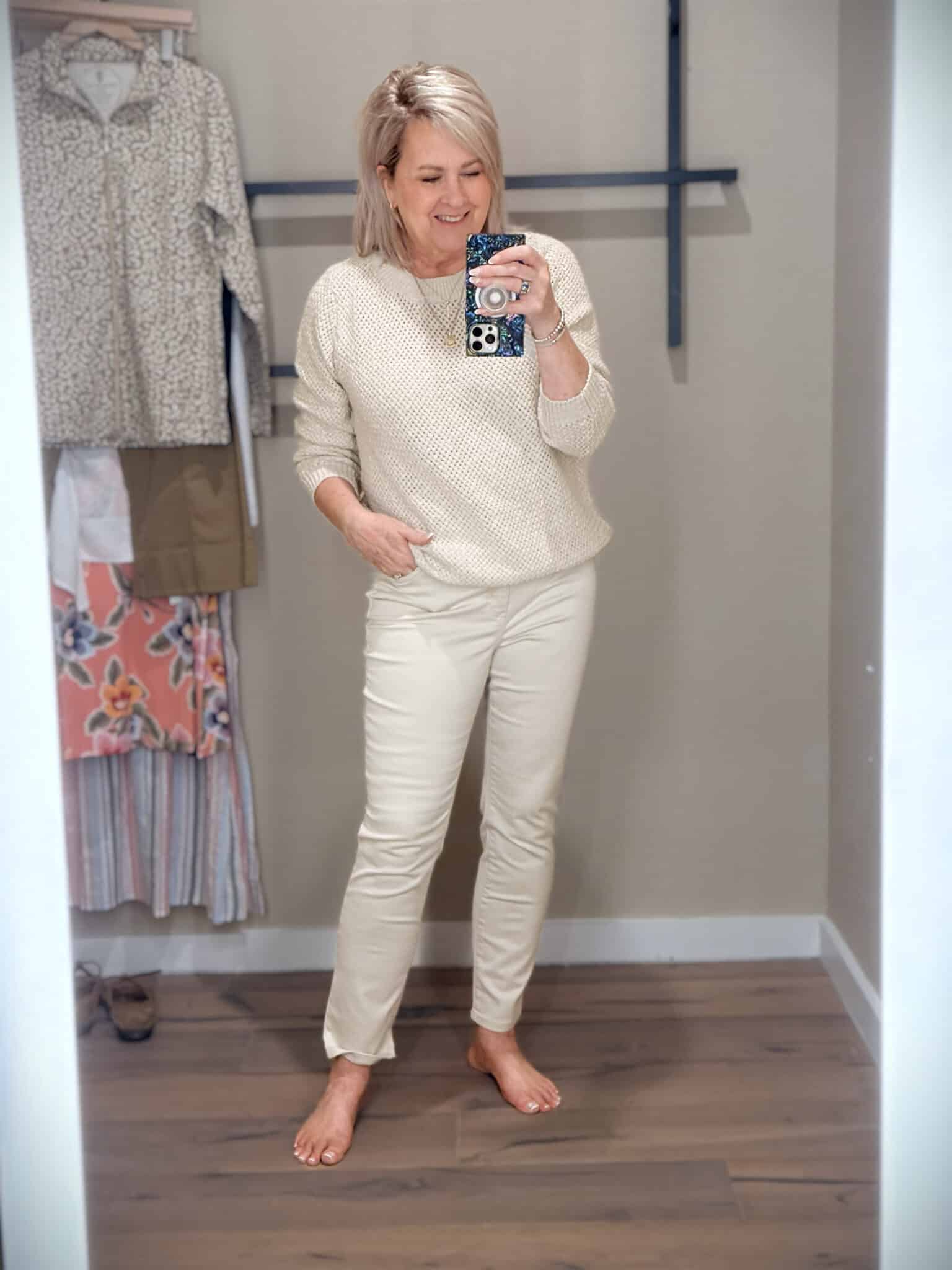 Tania wearing a neutral sweater and ivory jeans from Tommy Bahama